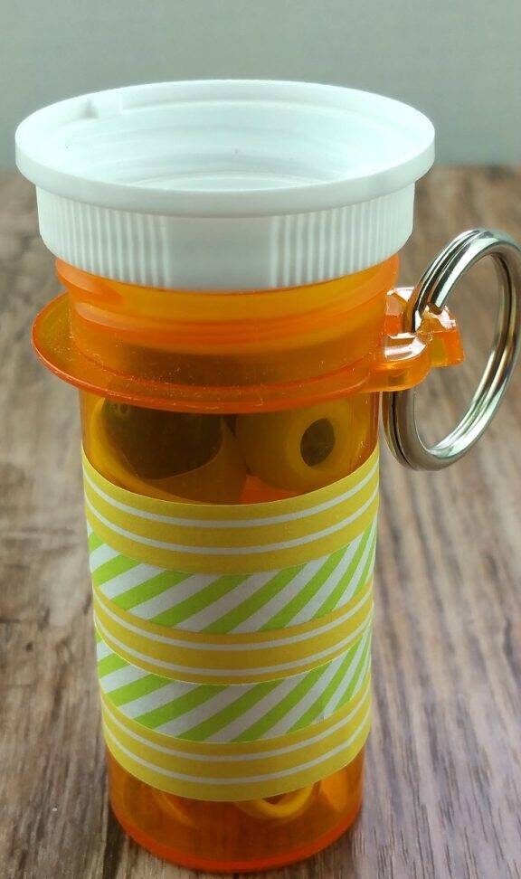 An RX bottle upcycled for earbud storage.