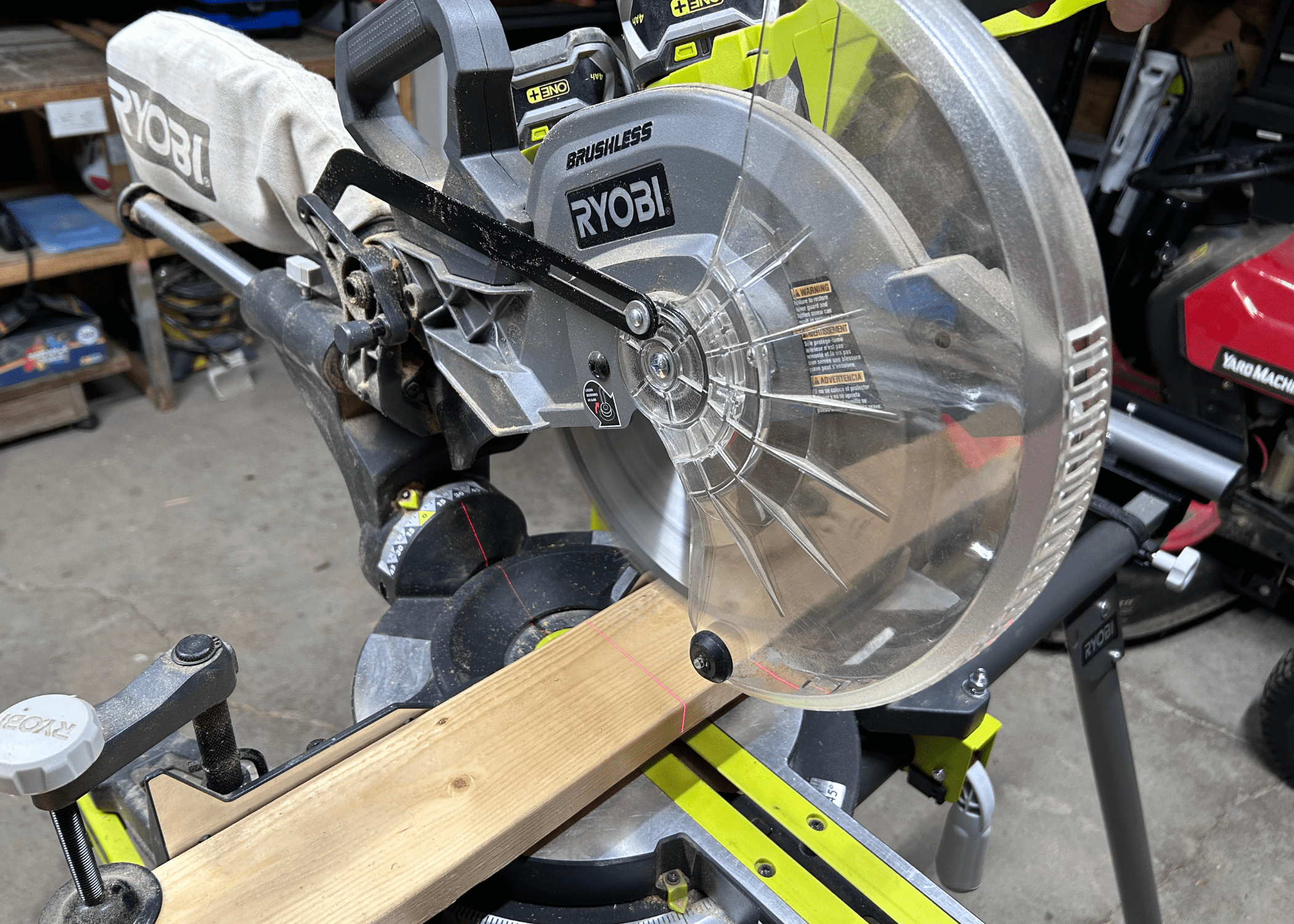 miter saw about to cut a piece of wood
