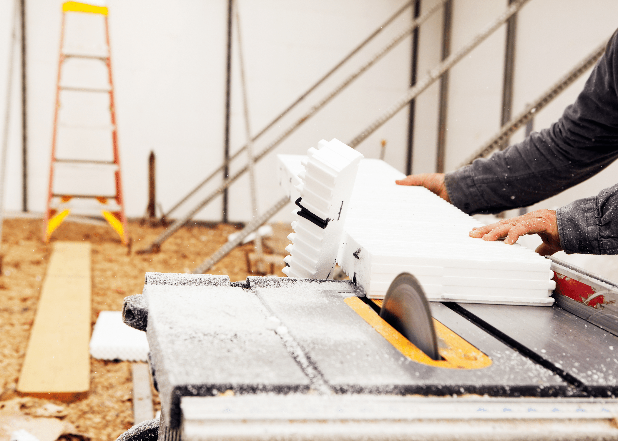 close up of man cutting on a table saw