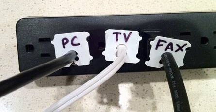 An assortment of cords with labels on bread tabs.