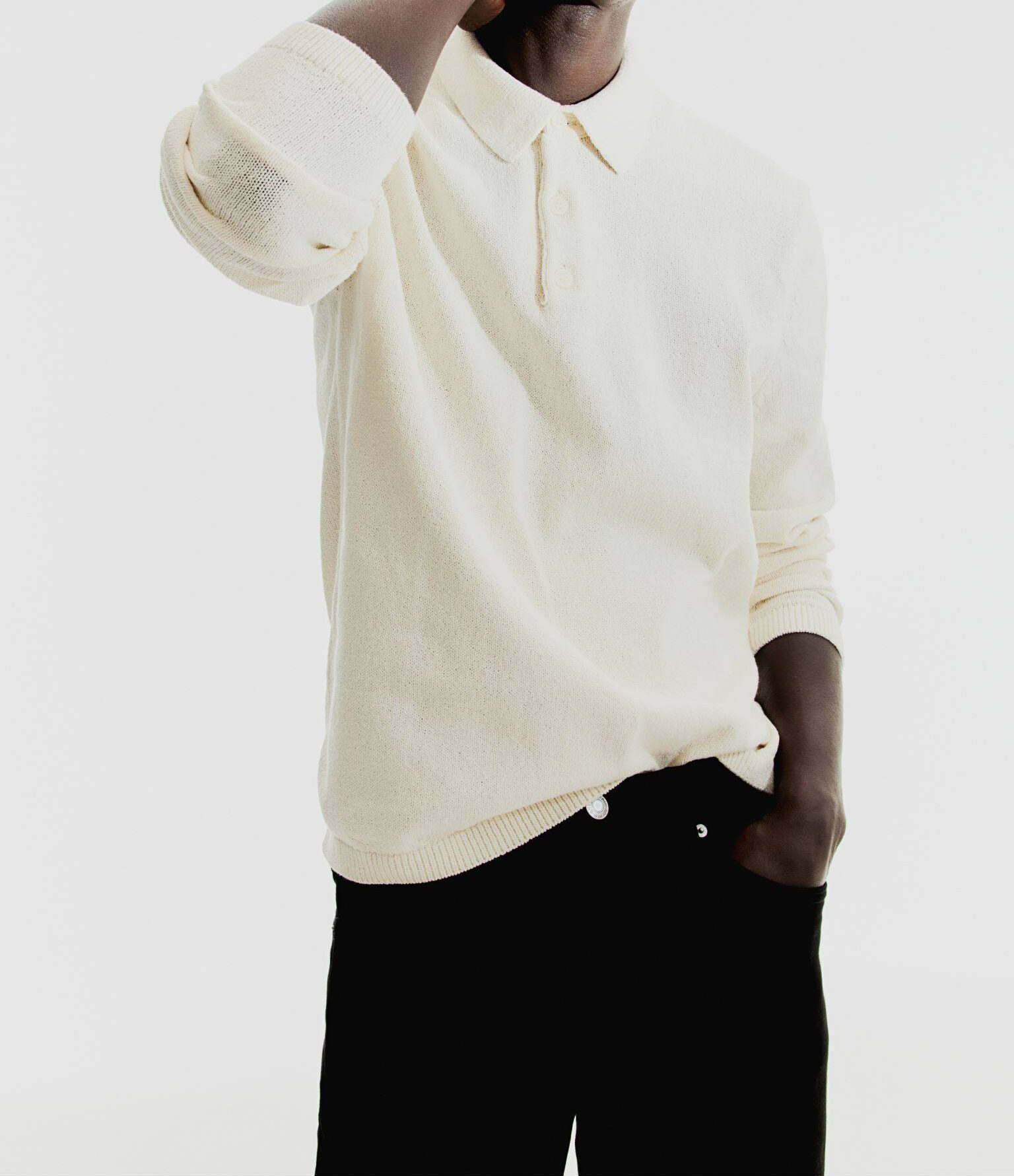 A man modeling a knit polo shirt.