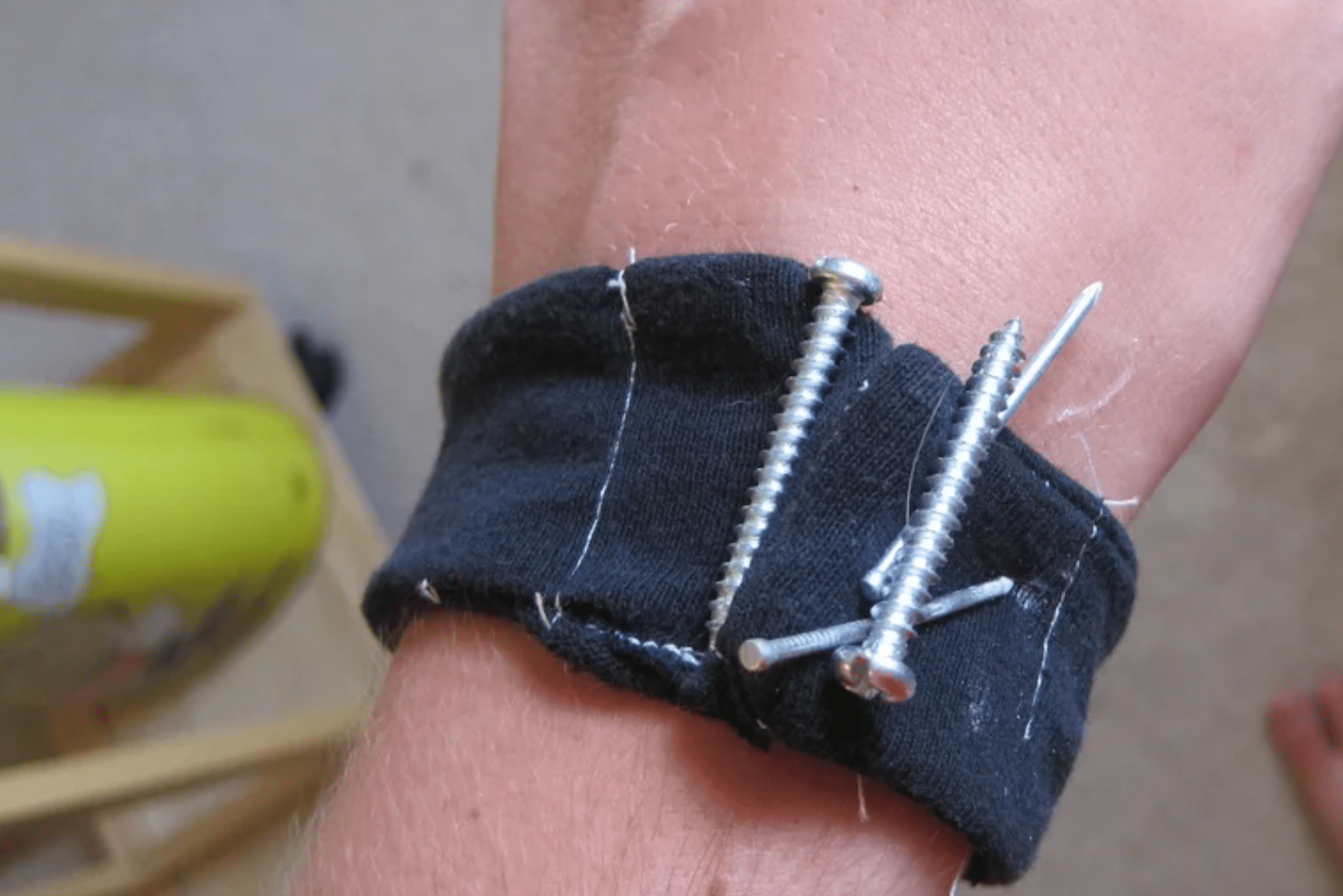 A magnetic wrist band with screws attached to it.