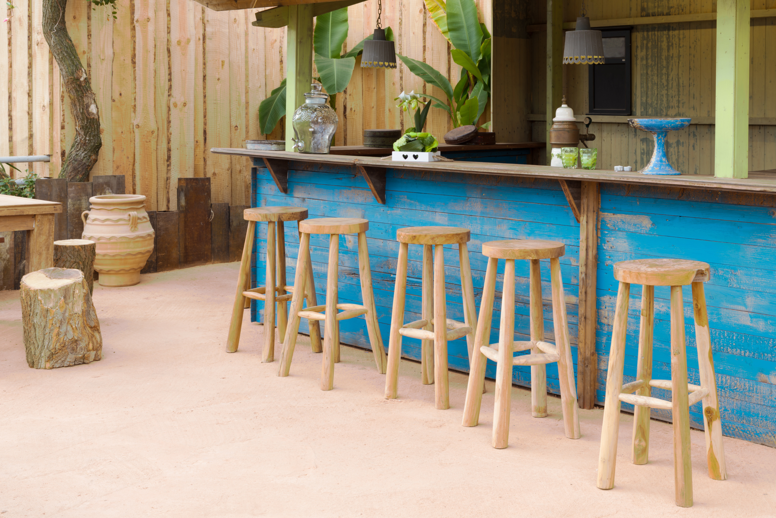 A wooden DIY outdoor bar with blue color.