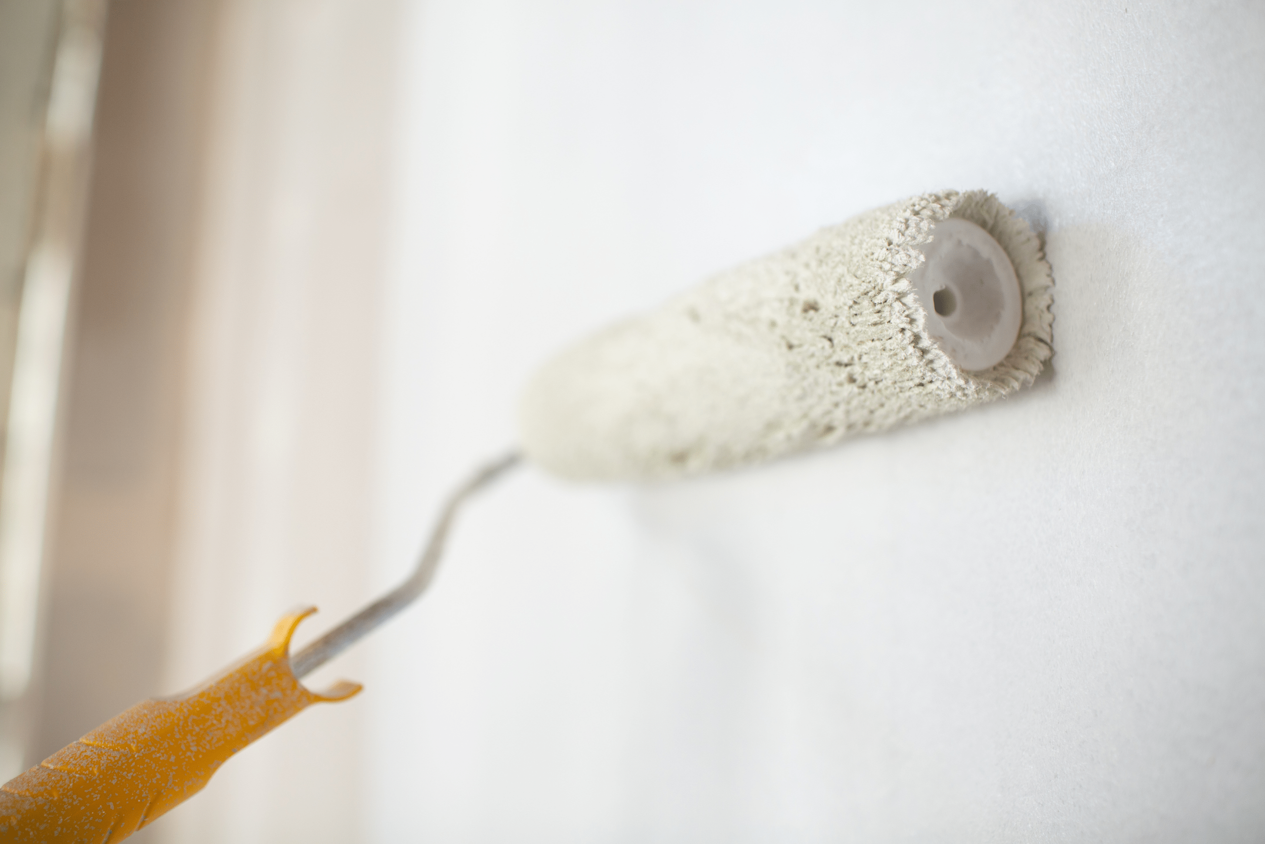 A paint roller on the wall.
