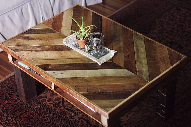 A rustic pallet coffee table in a living room.