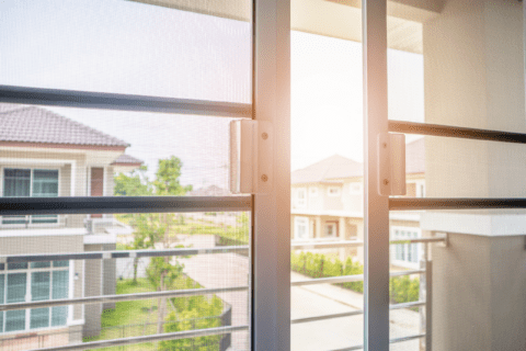 Double screen doors installed flanked by sunshine.