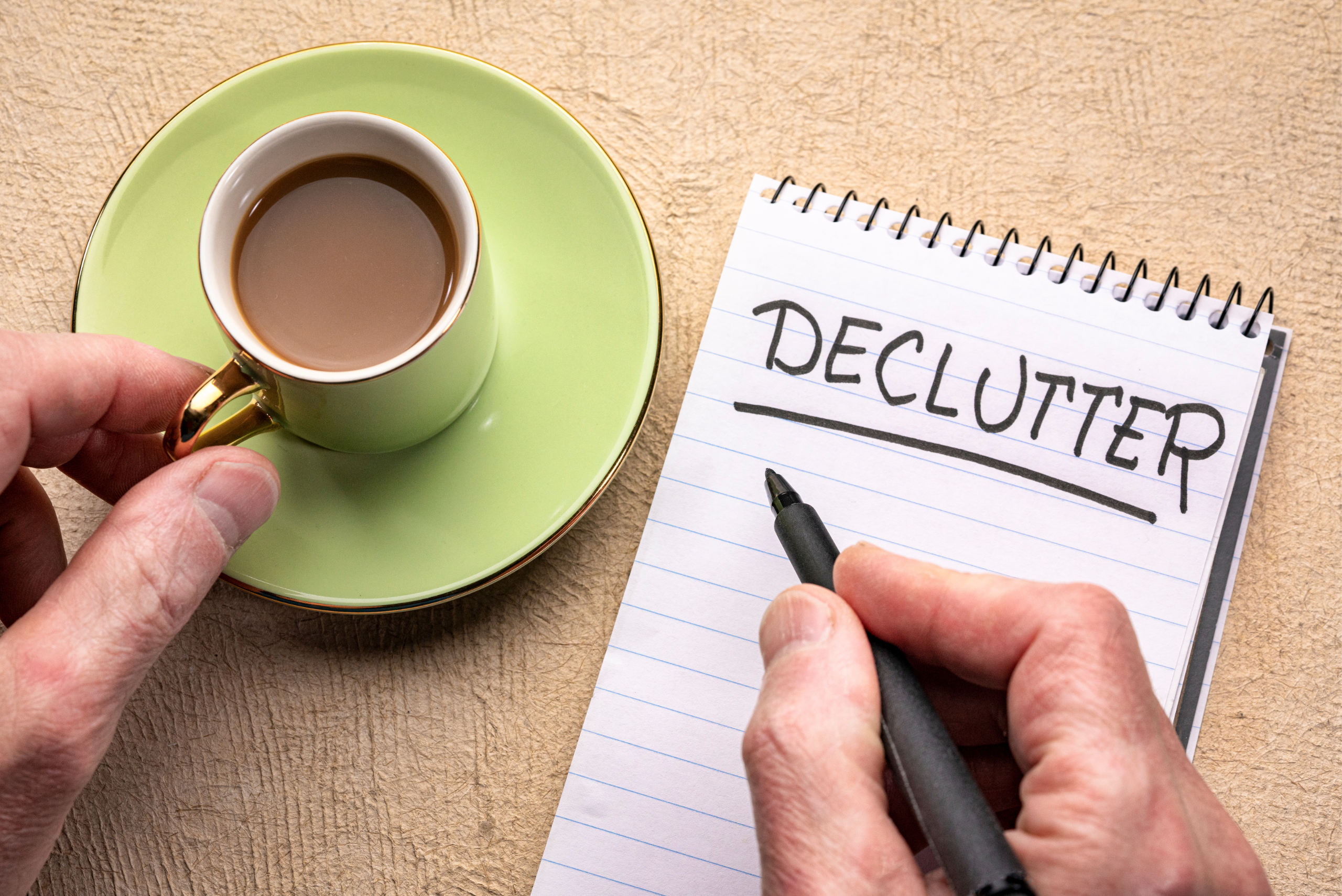 A coffee cup and notepad that reads "DECLUTTER"