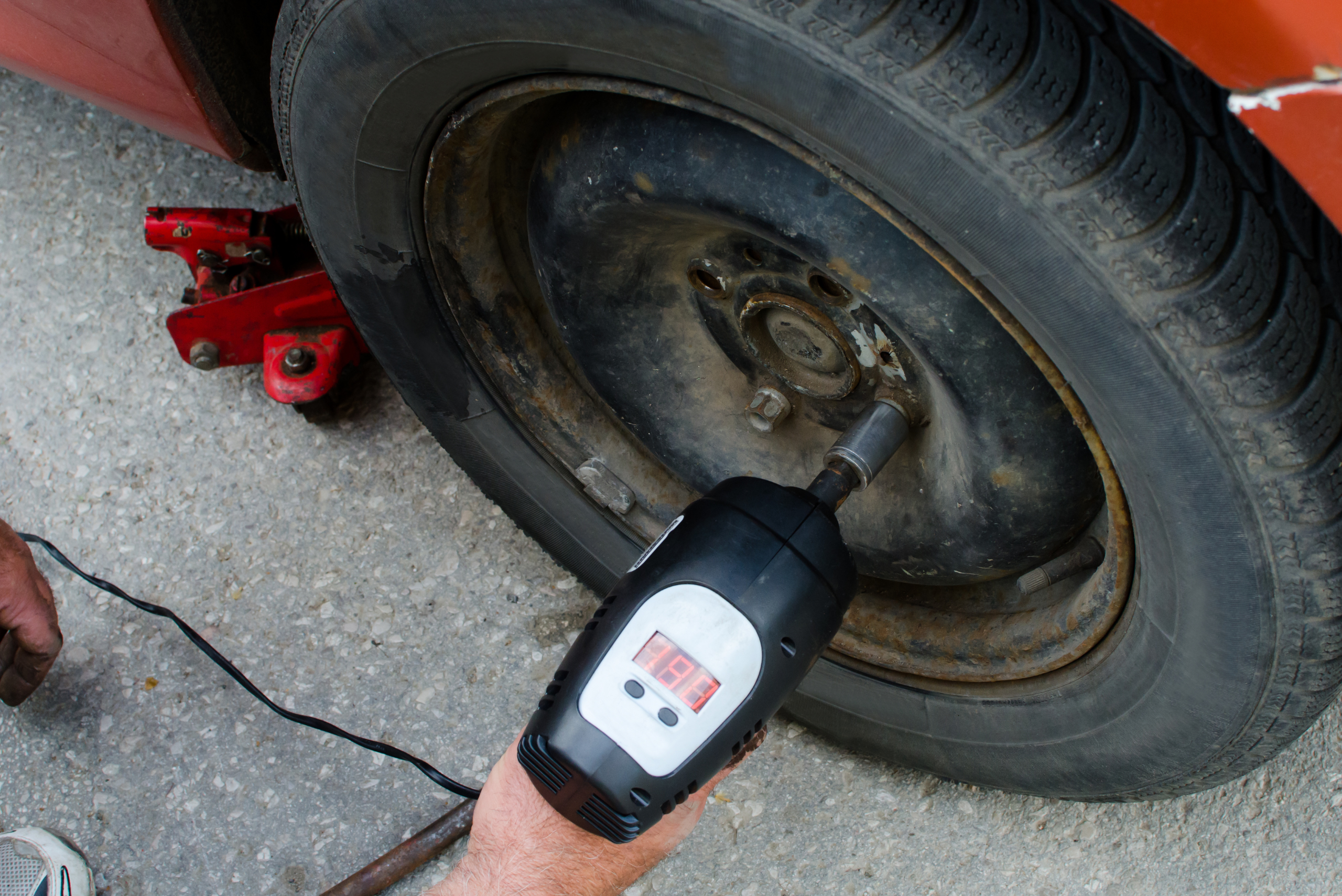 Removing lug nuts using impact wrench.