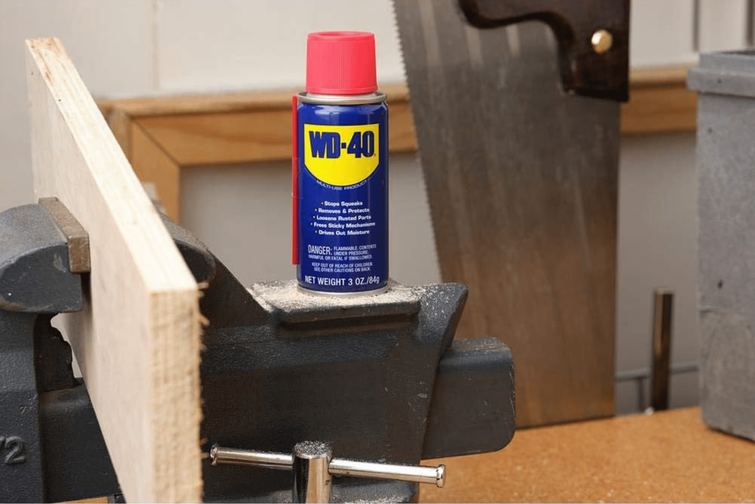 A can of WD-40 on a workbench vice.