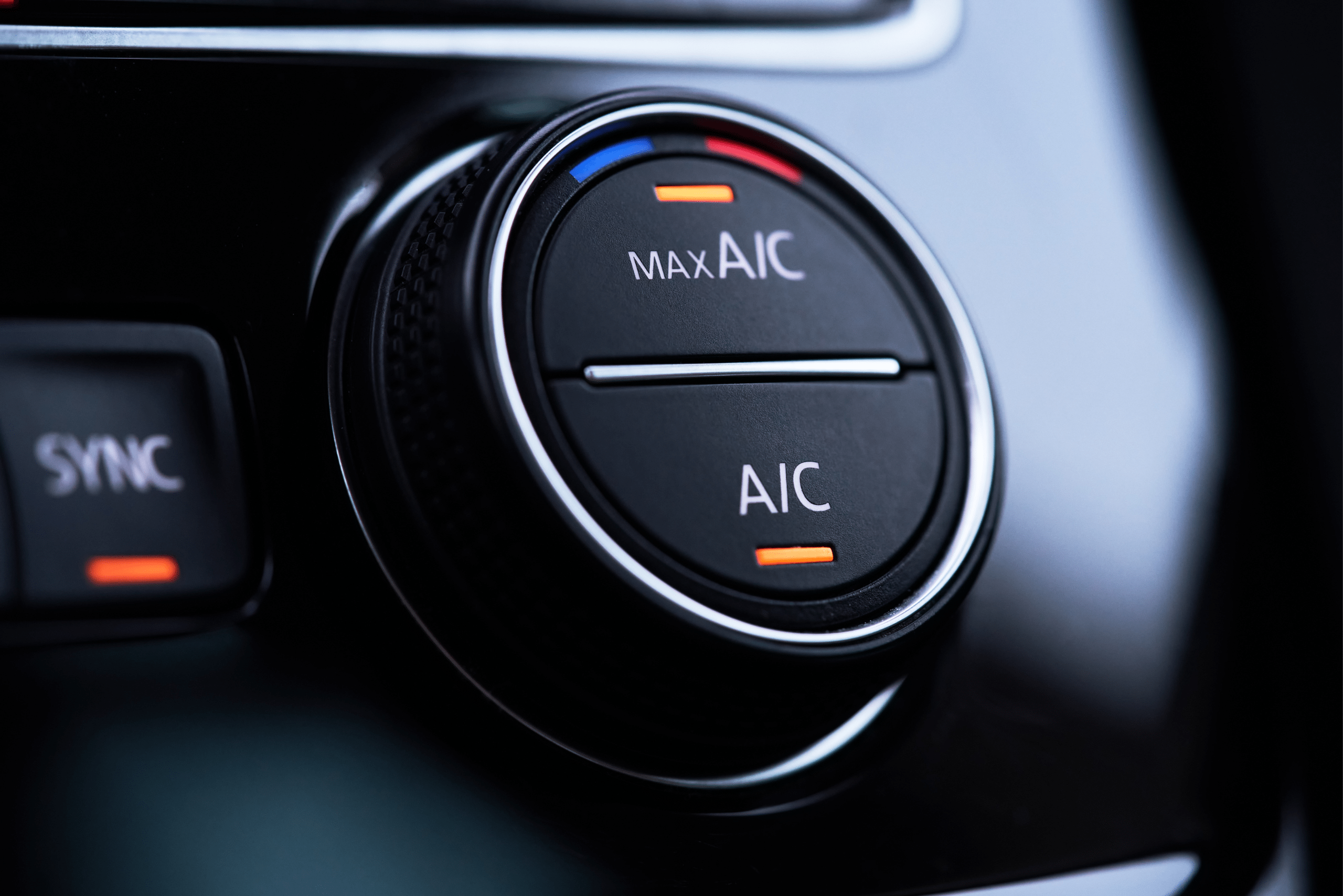 A closeup of max A/C button inside a car interior.
