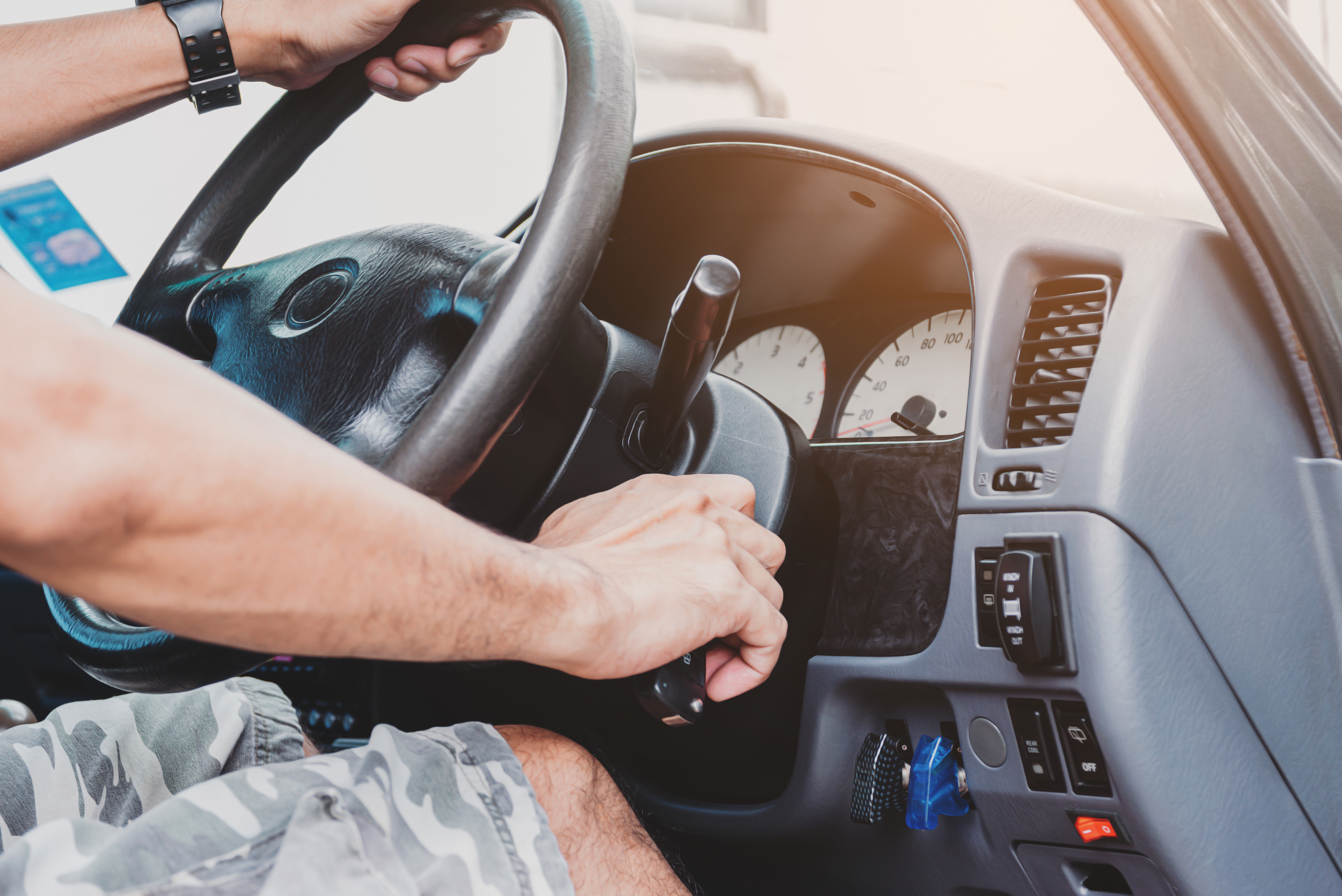 A person cranking over the engine using a key.