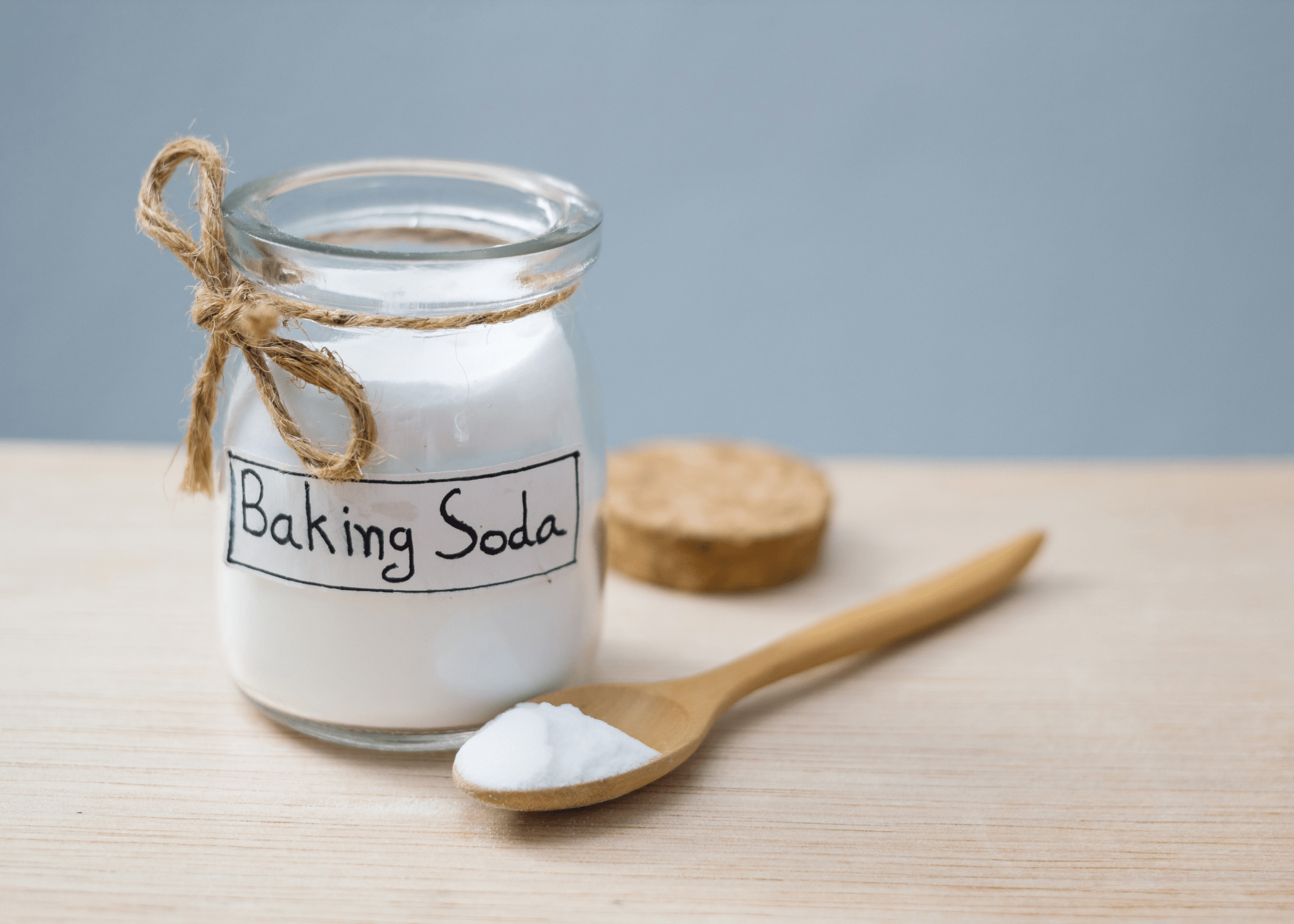baking soda in jar and on wooden spoon