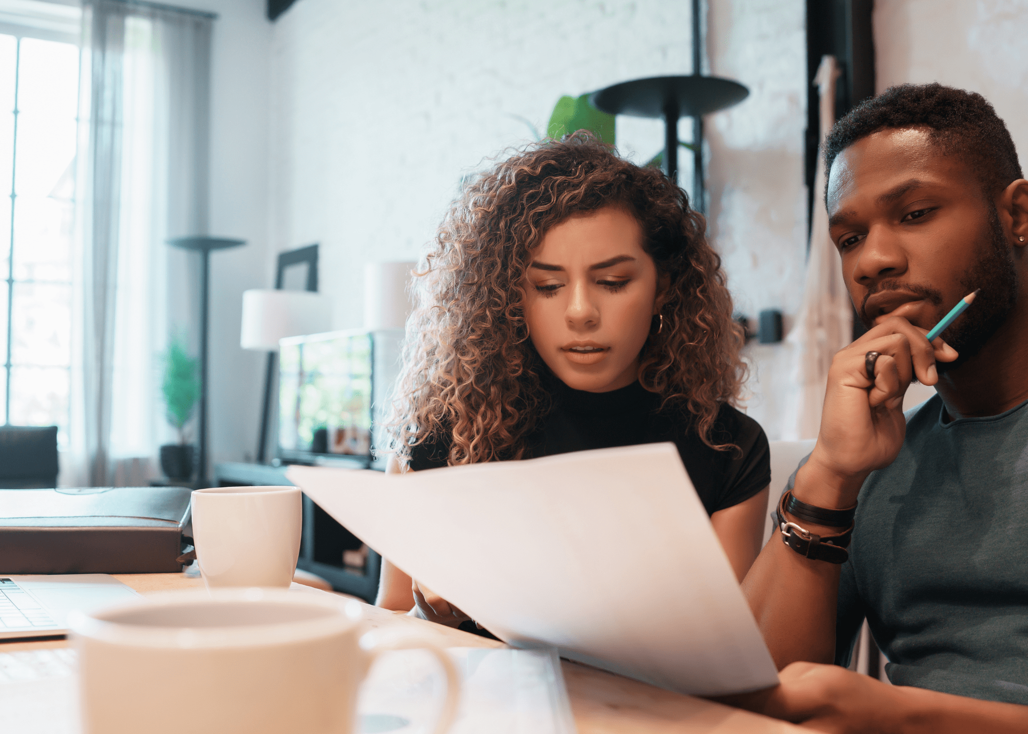 man and woman looking at paper