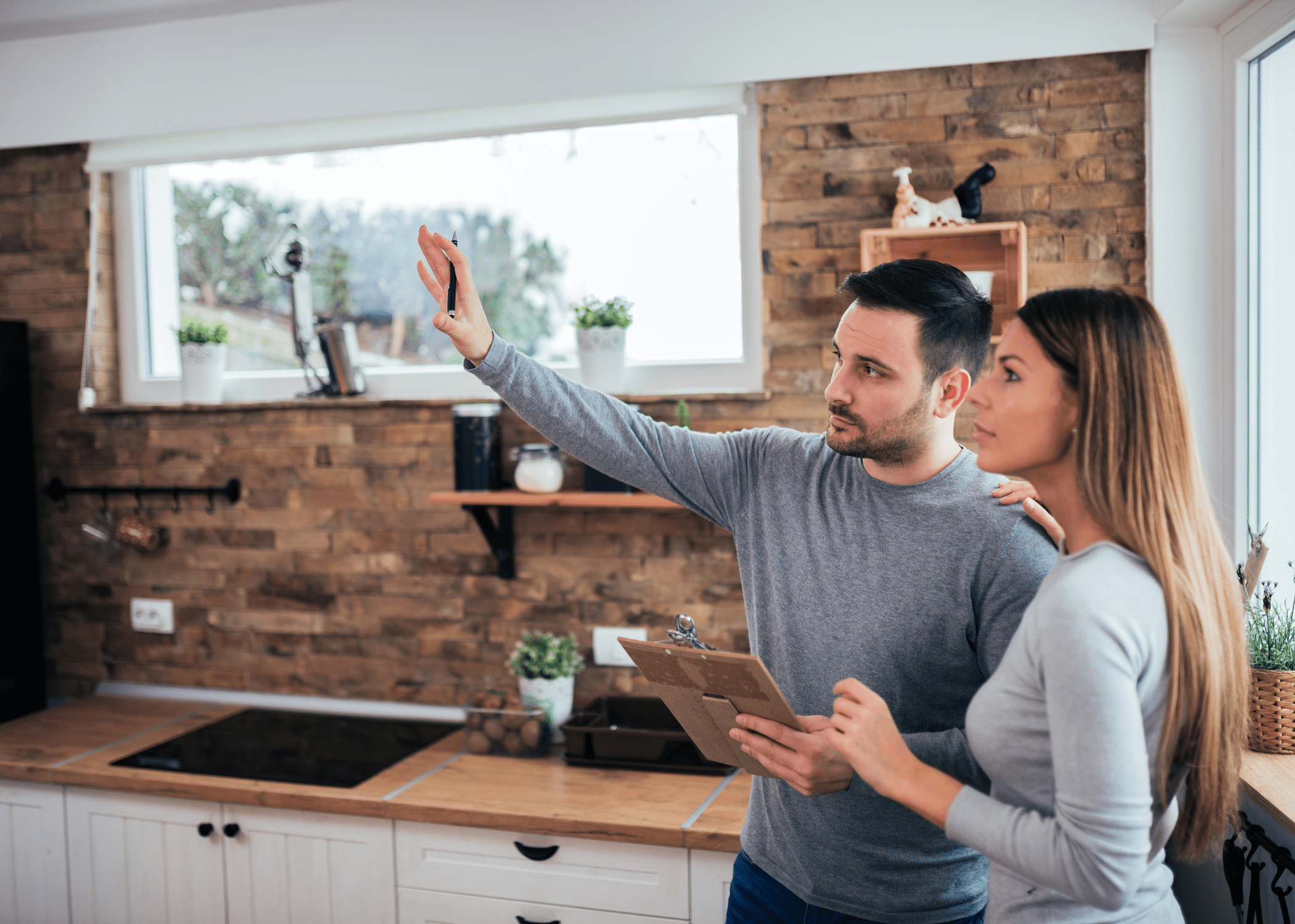 man and woman standing in house planning renovation