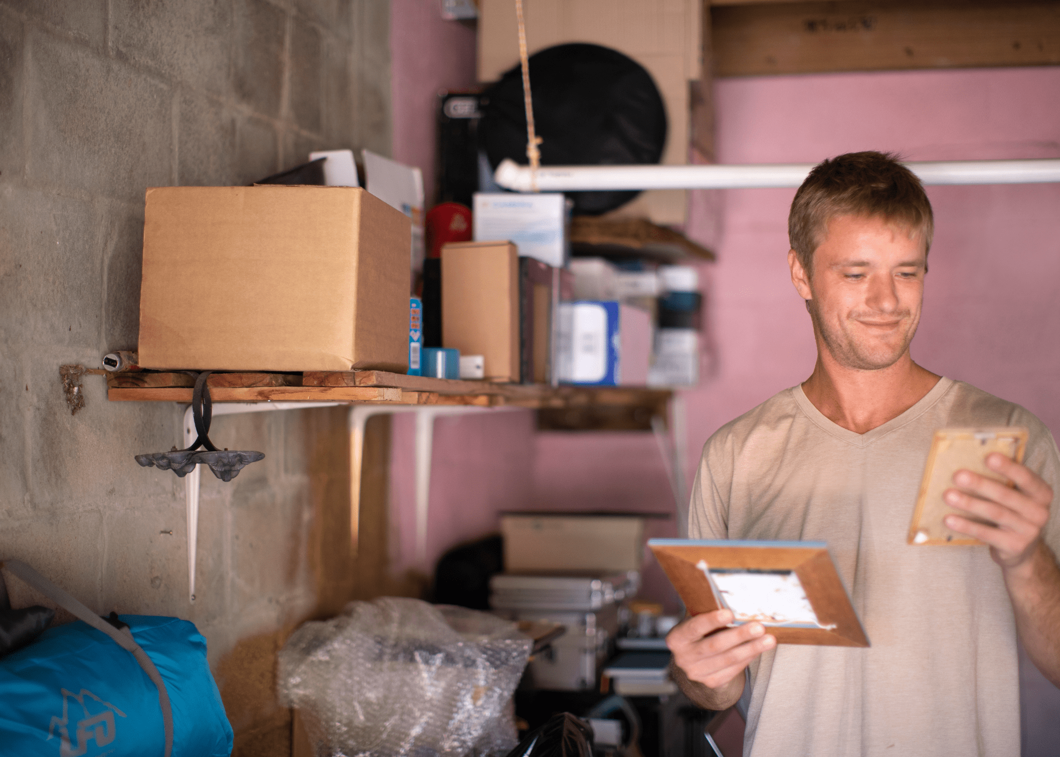 man organizing garage and going through boxes of stuff