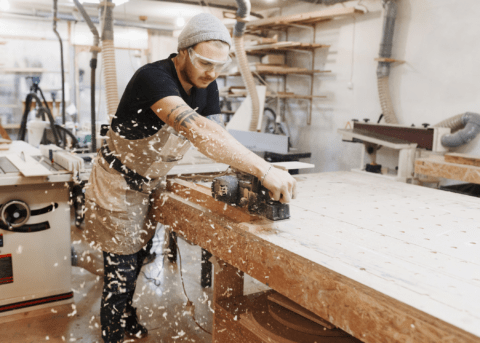 man working in a workshop creating sawdust