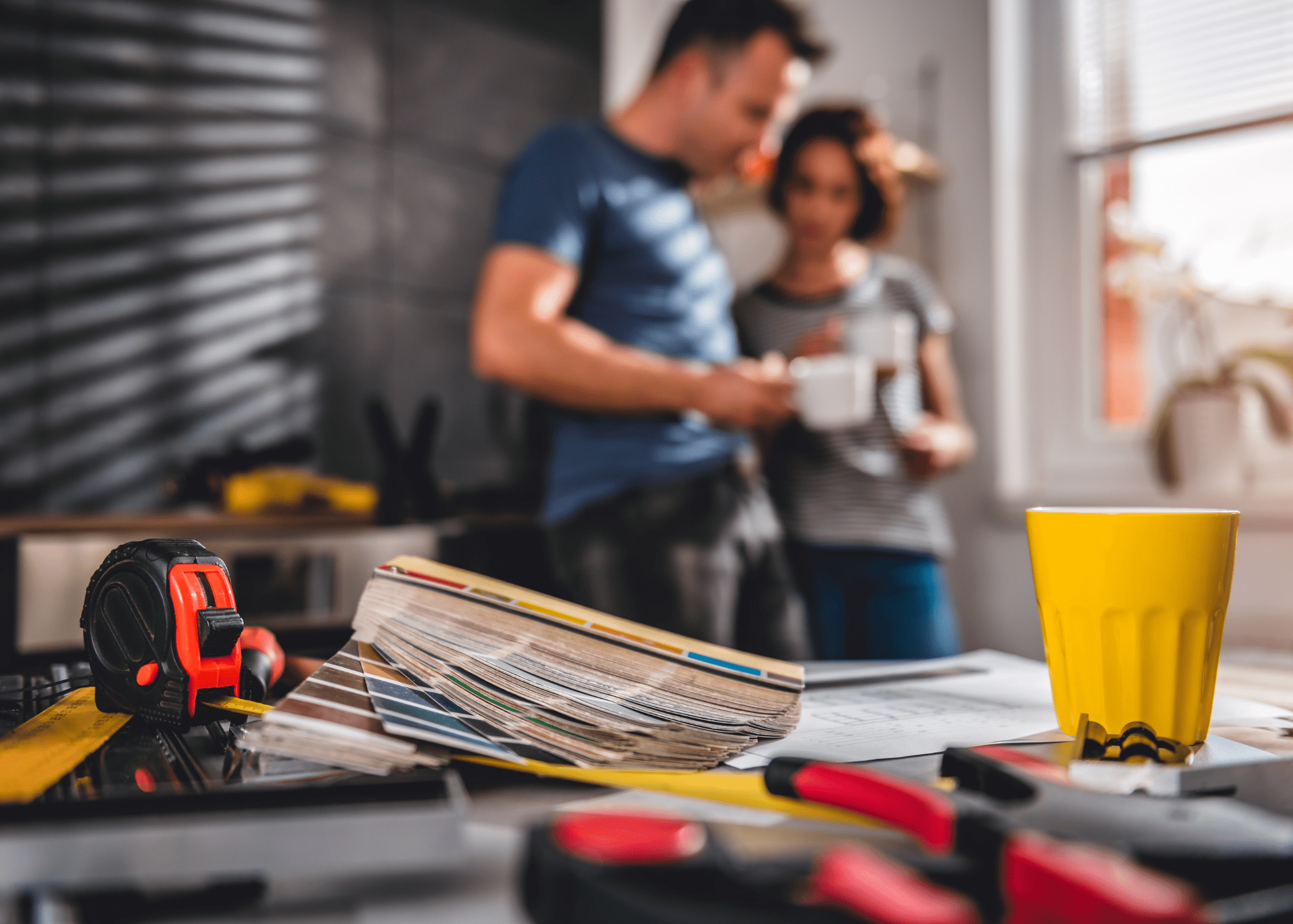 close up of renovation materials and a blurry man and woman in background