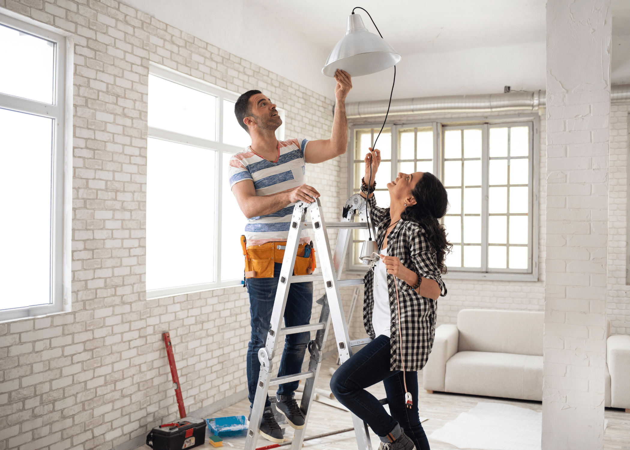 man and woman hanging up white light