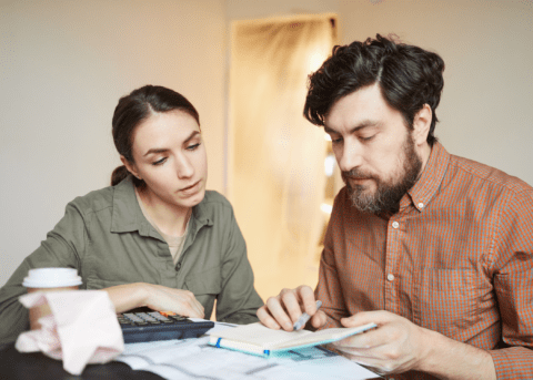 man and woman looking at budget plans