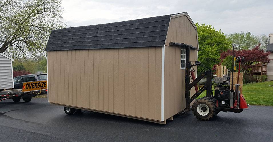 a shed being moved on a forklift