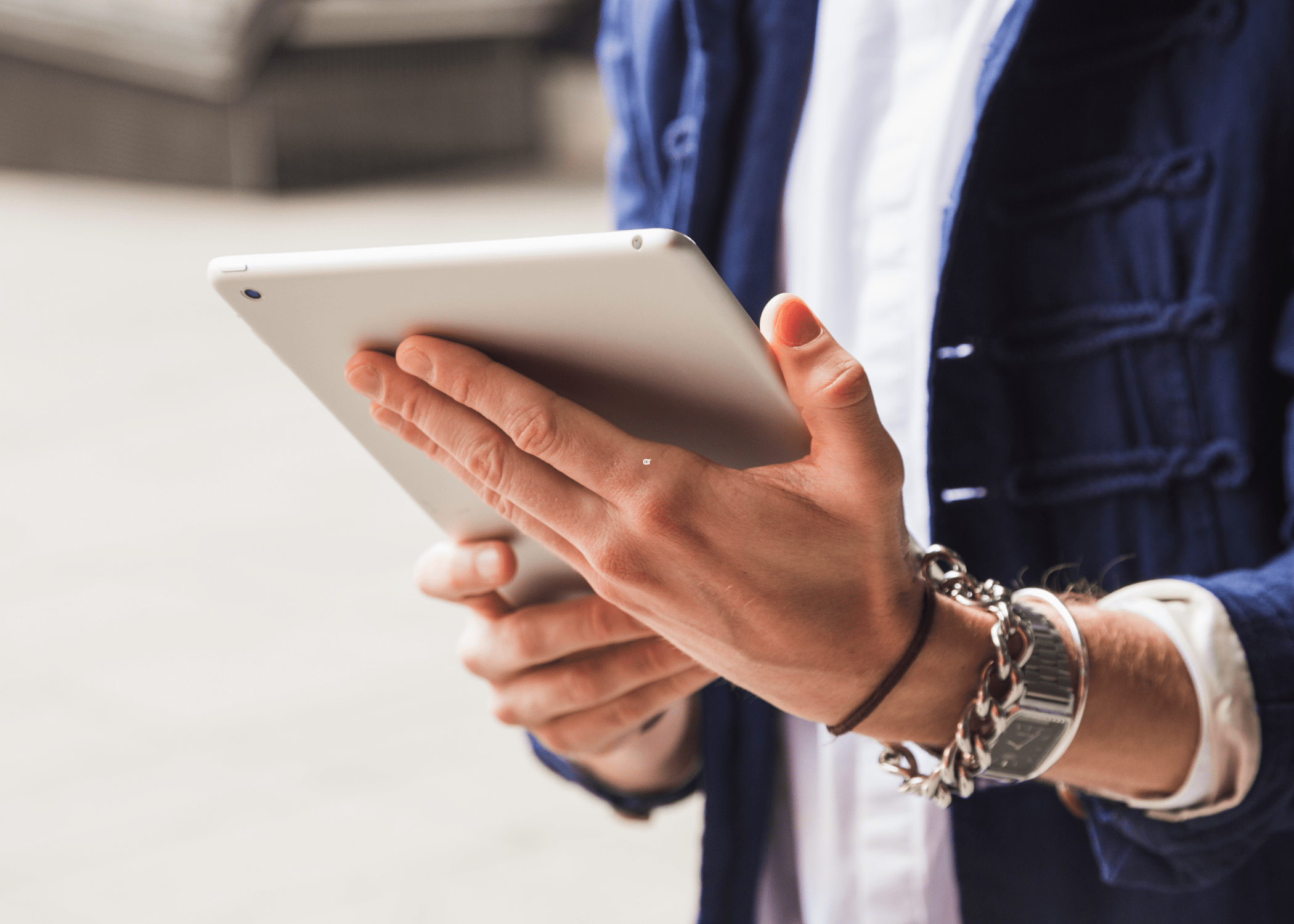 close up of hands holding an iPad