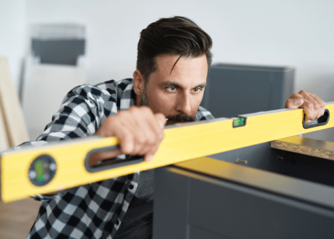 man using yellow bubble level