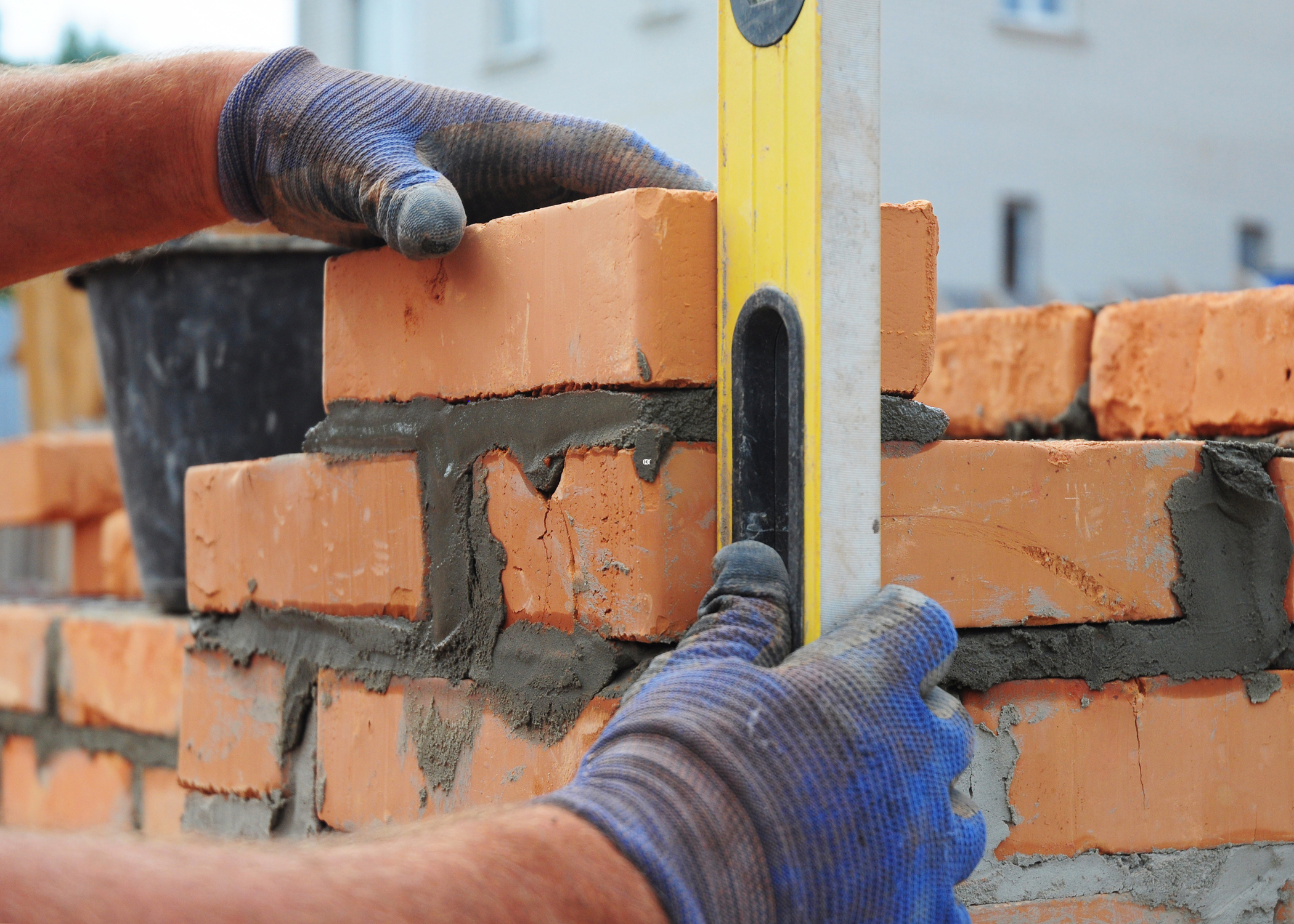 using a yellow level while laying bricks