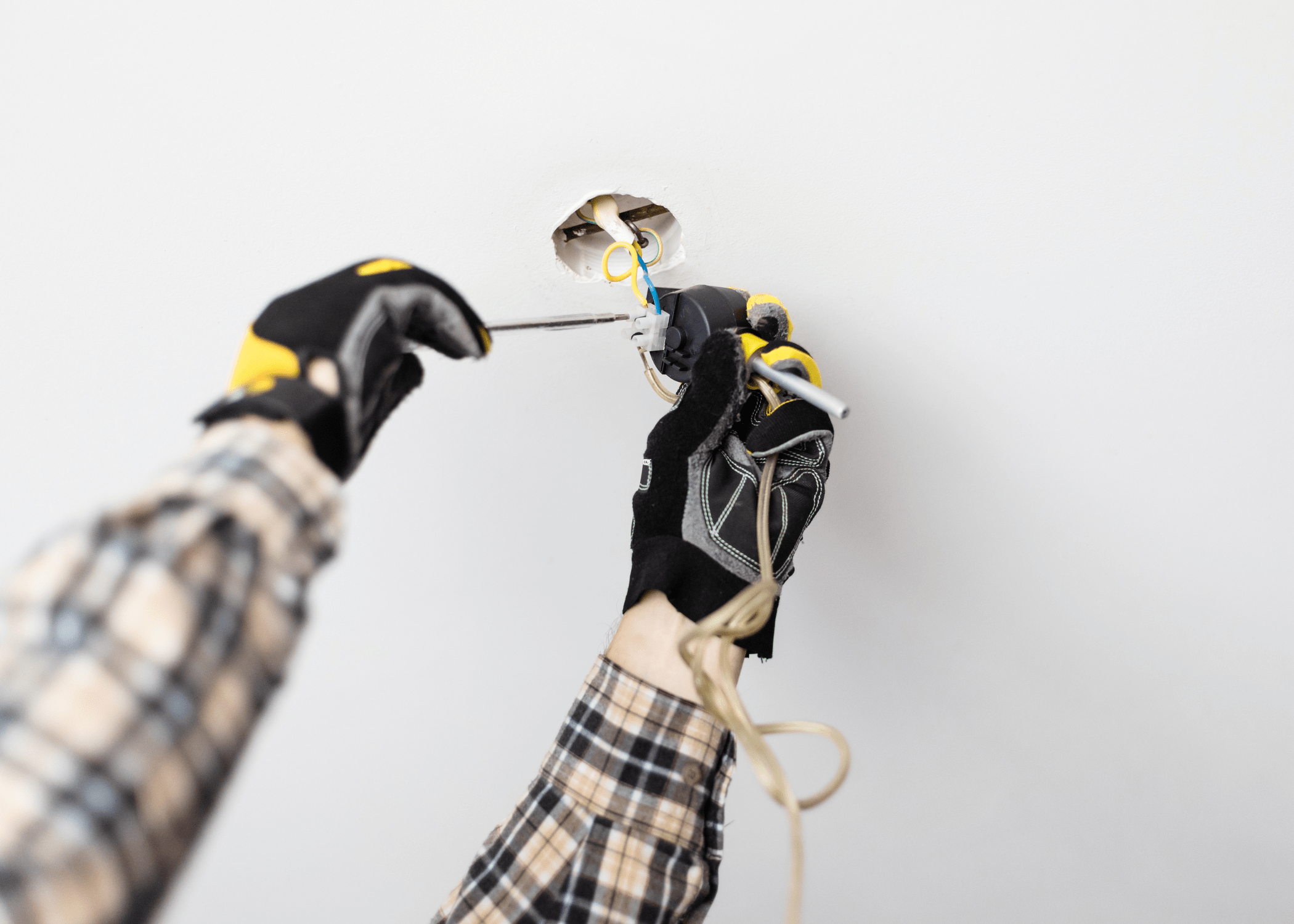 gloves hands fixing a light socket