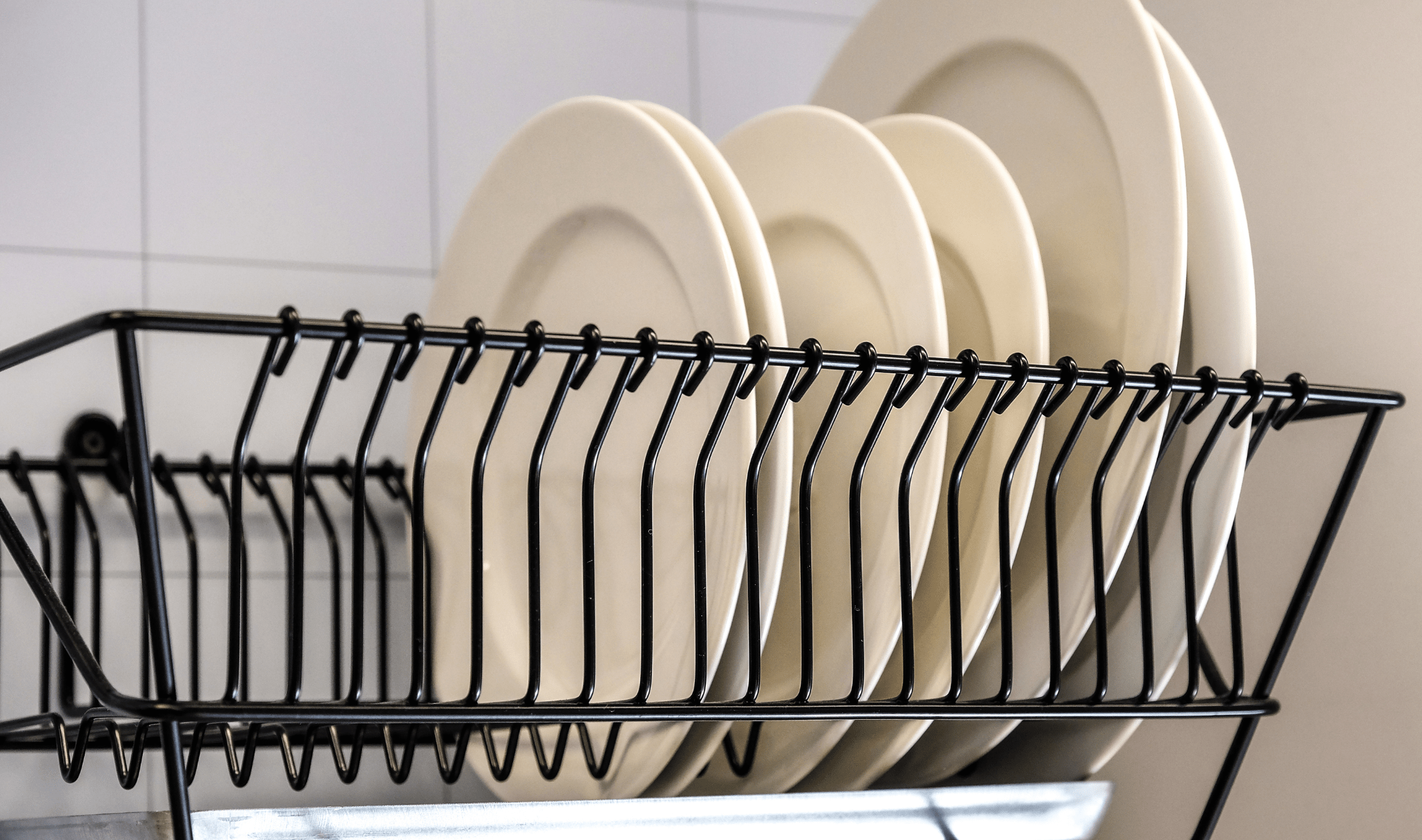 A dishrack with some plates in it.