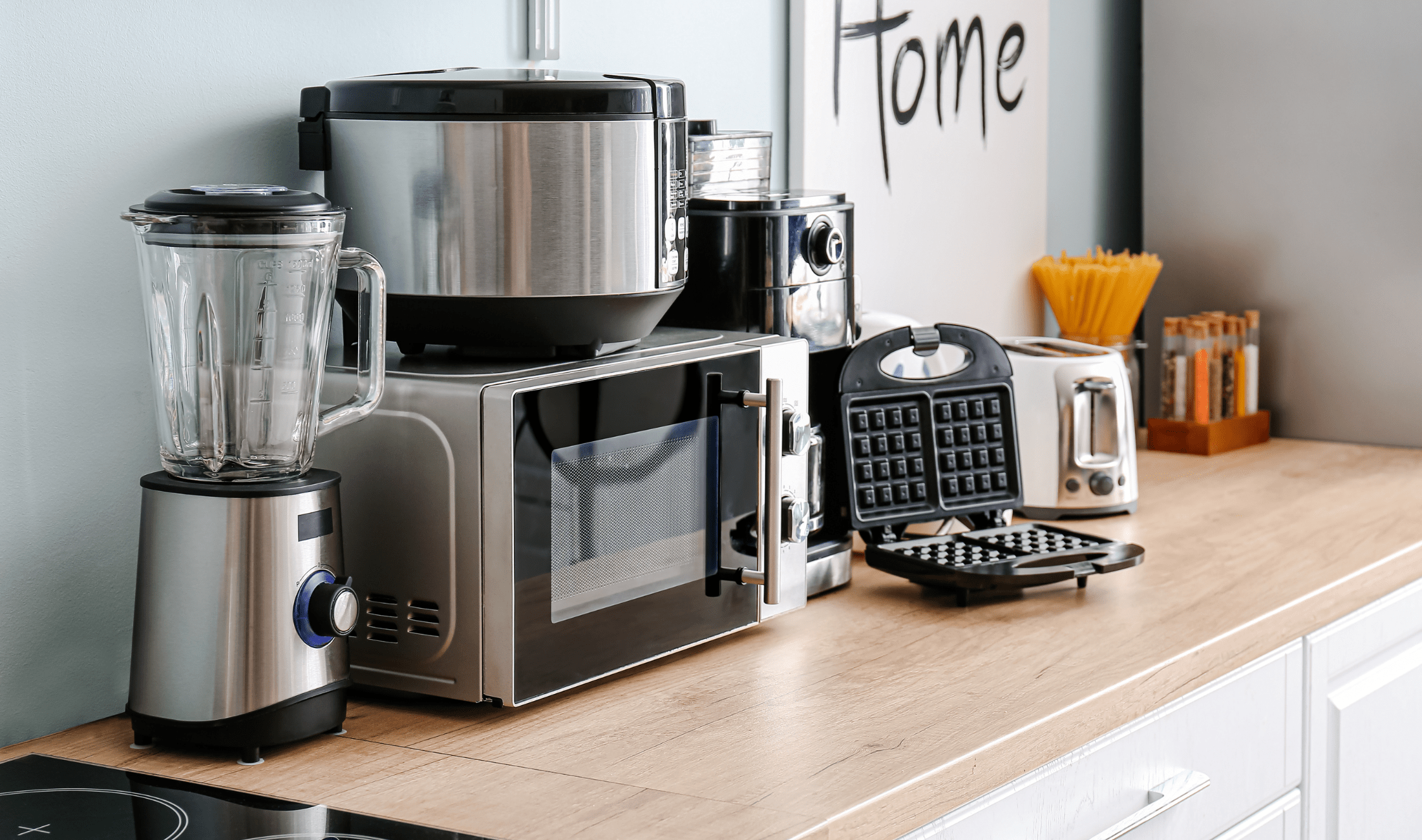 A collection of countertop appliances in a bright kitchen.