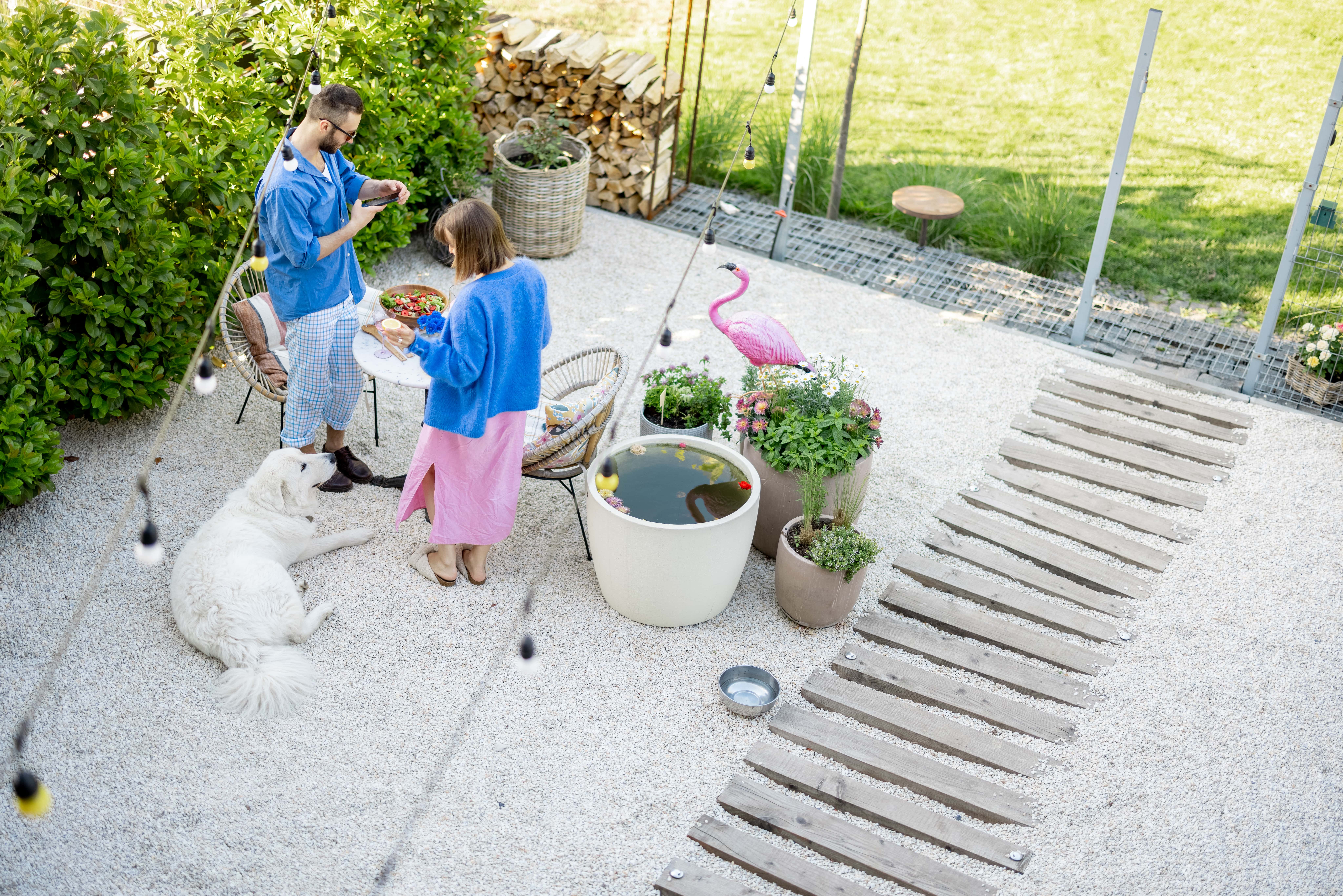 A couple outside on their gravel patio.