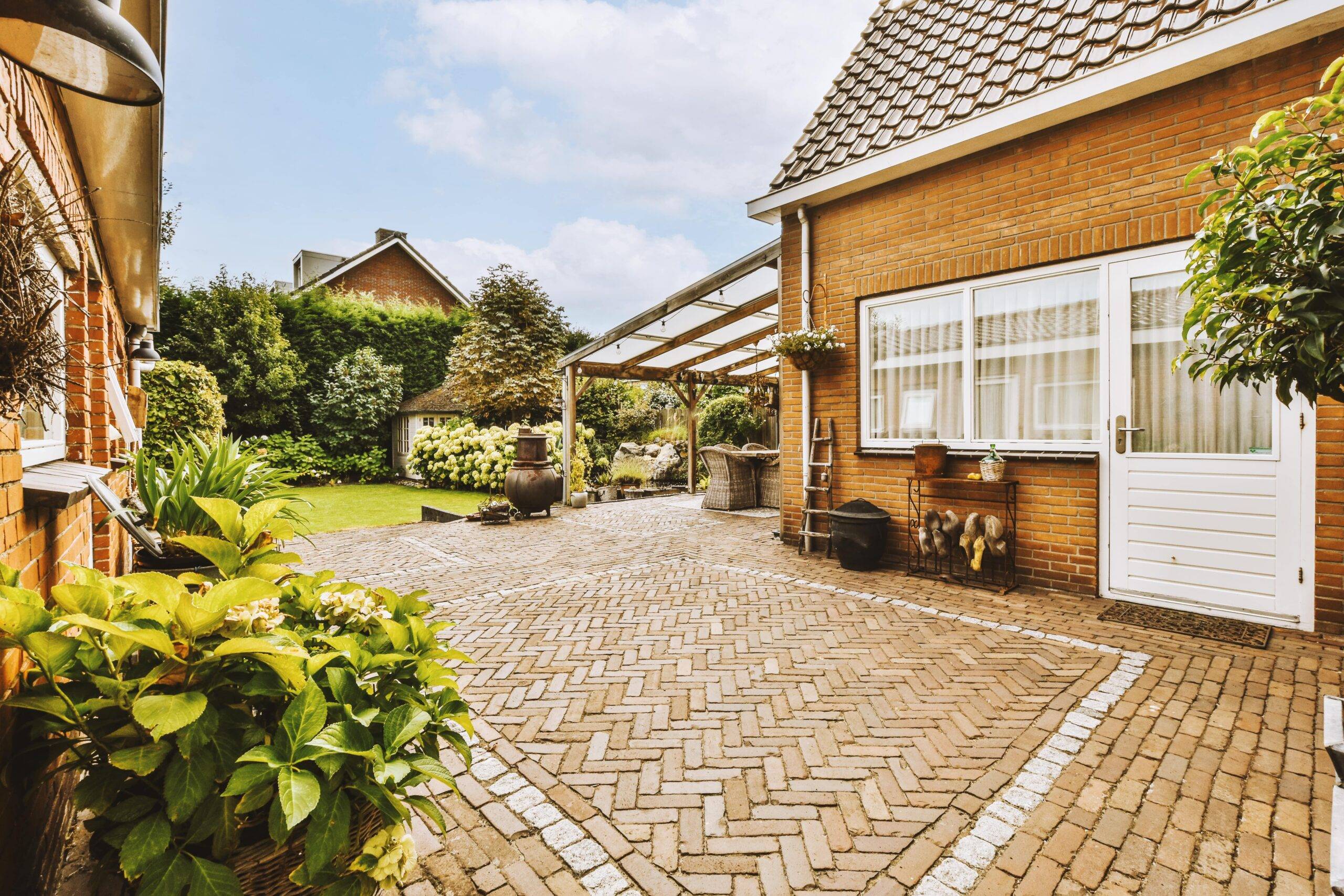 A cottage home with a rustic brick patio.