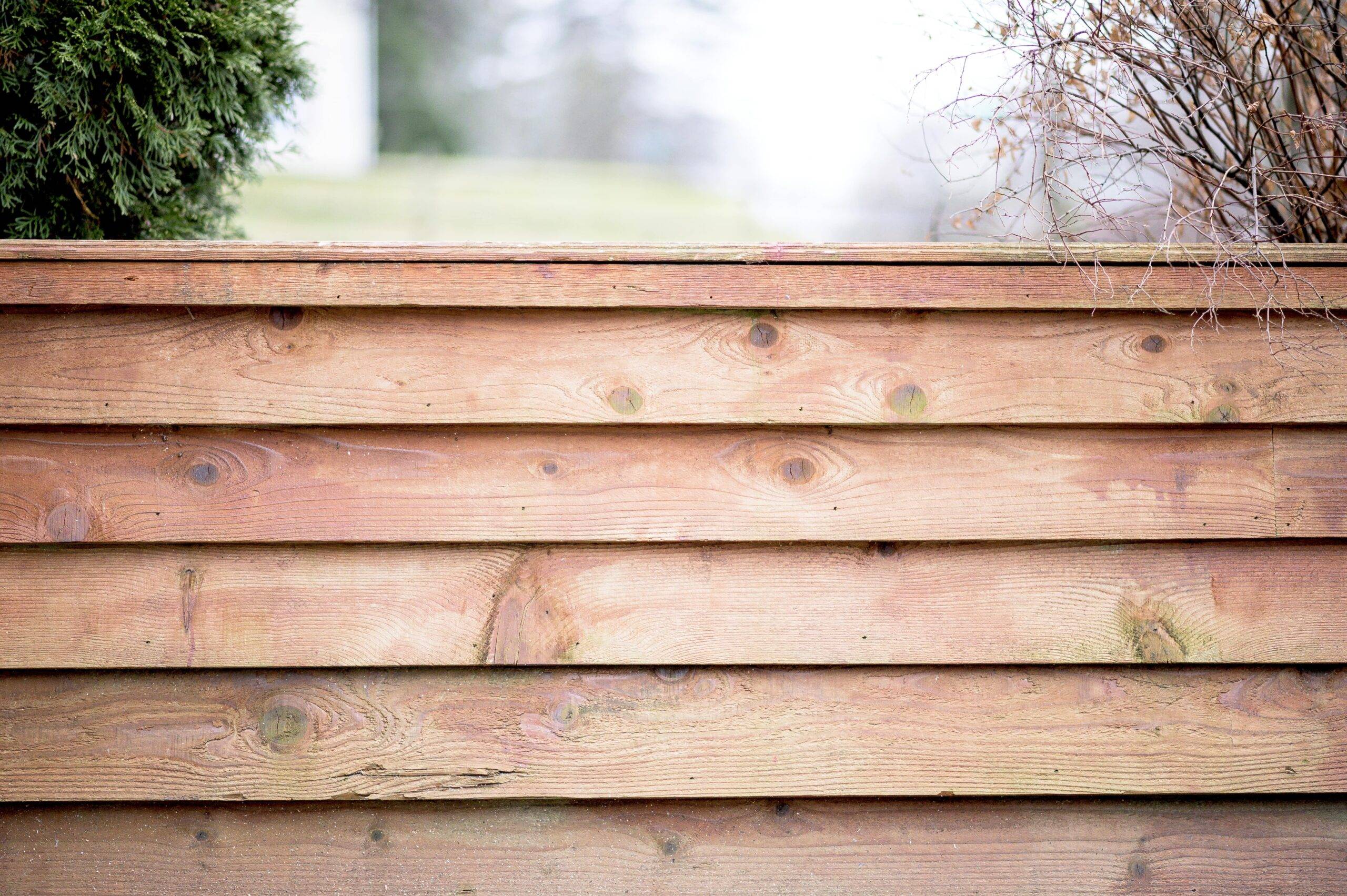 A close photo of a horizontal slat fence.