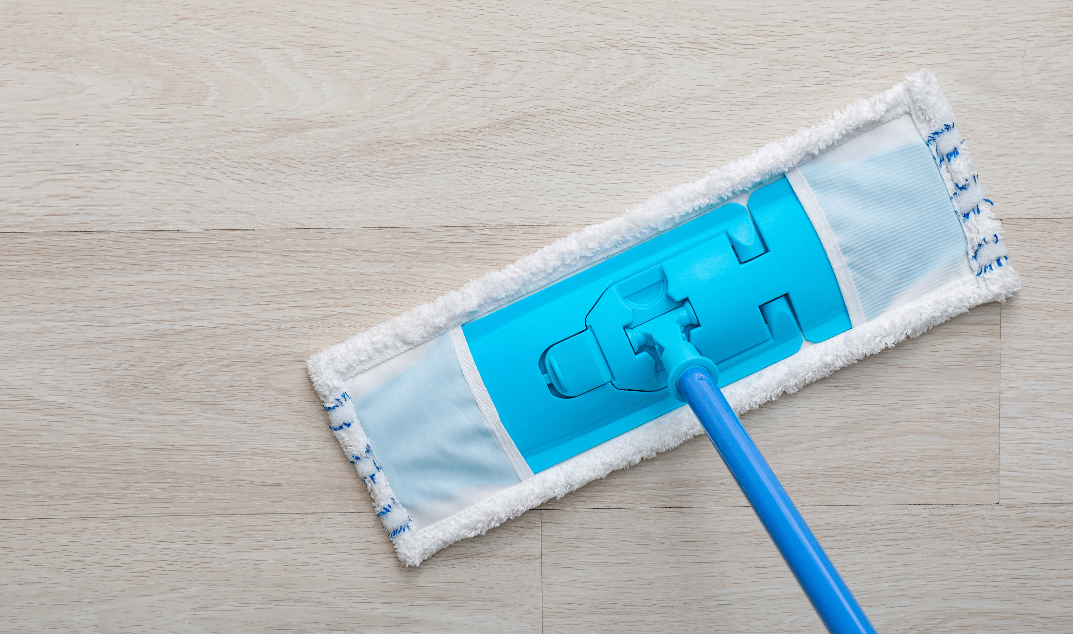 An above view of a swiffer-like mop against a floor.