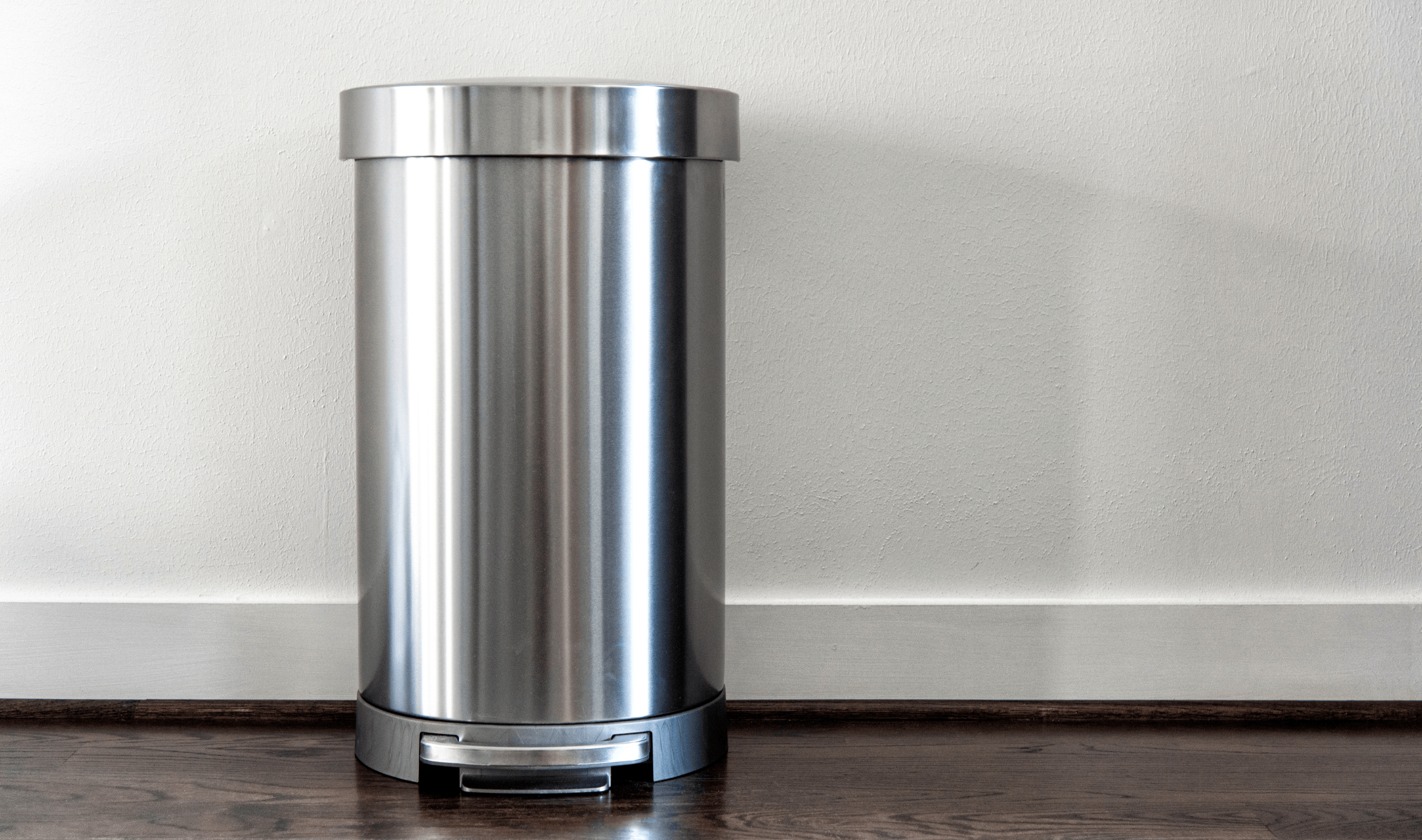 A silver garbage can.