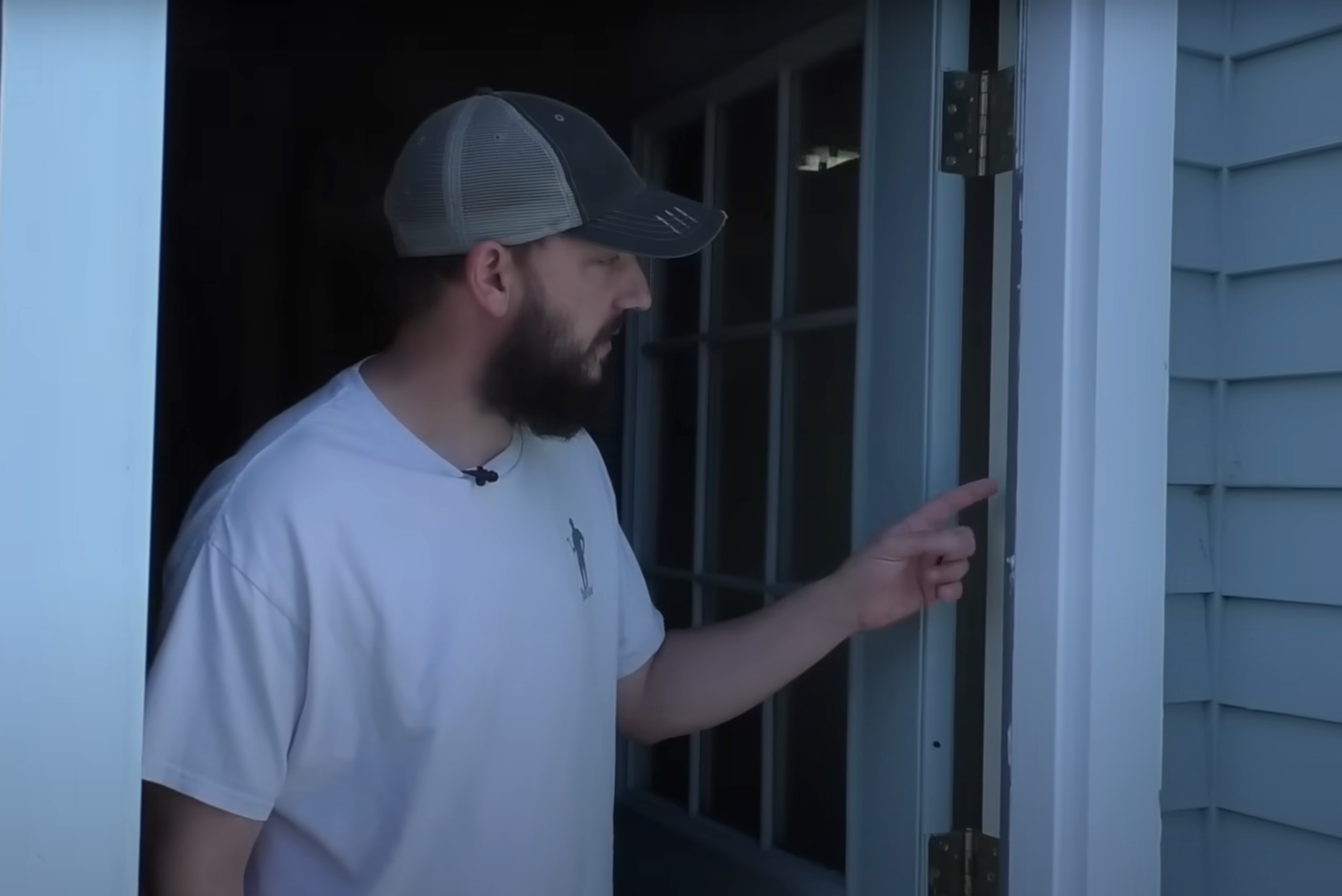 Man pointing to door seal.