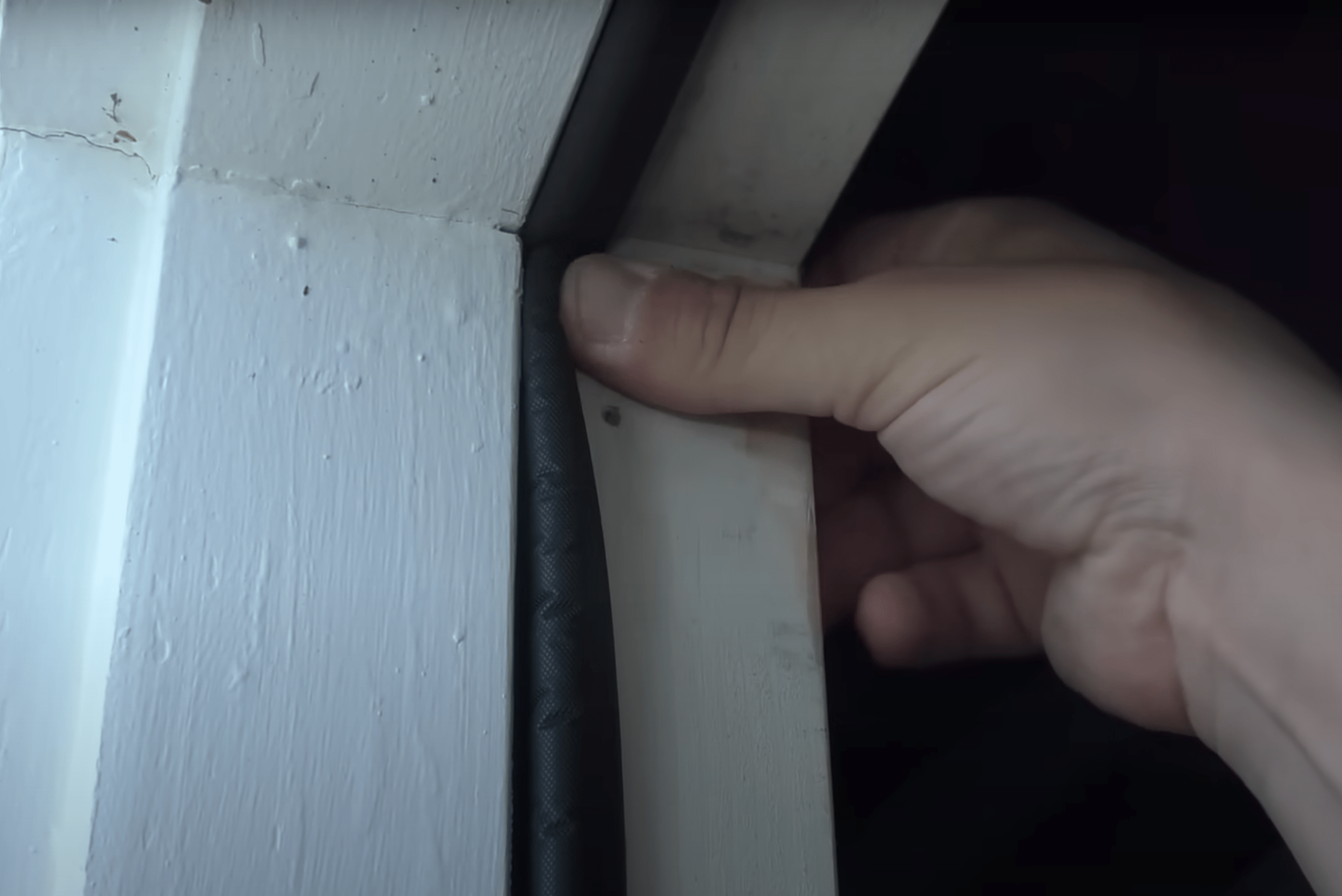 Pressing the door seal into the frame using hand.