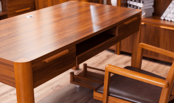 A closeup of an all-wood desk with natural grain patterns.