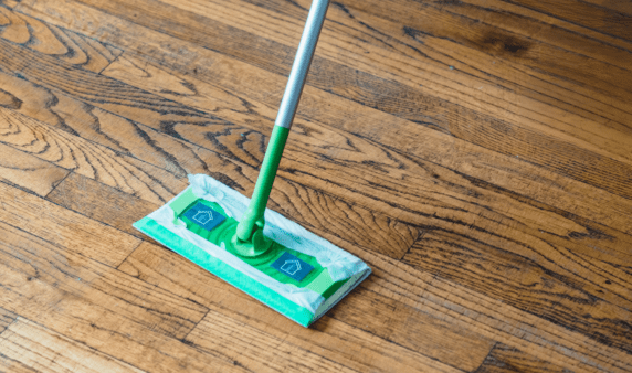 An above view of a swiffer-like mop against a floor.