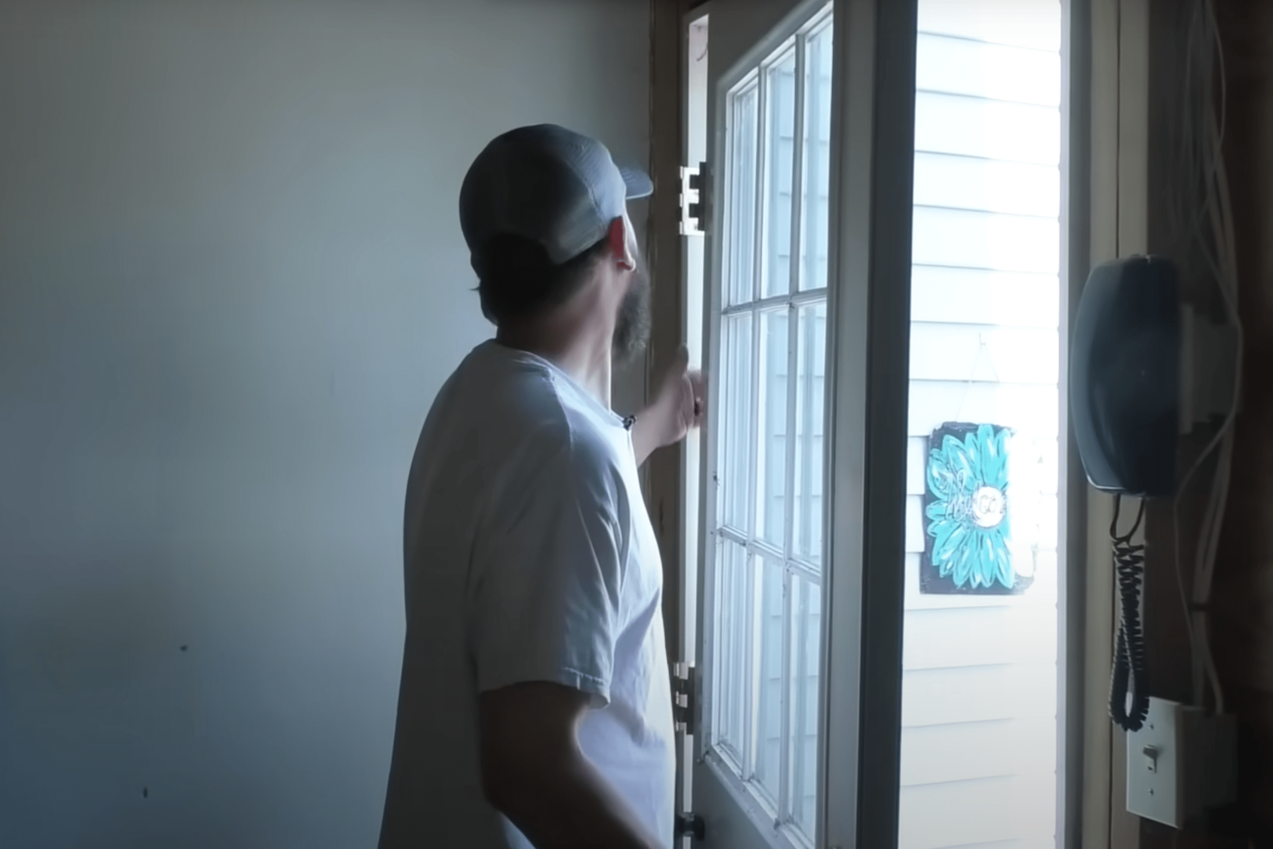 Man removing door from hinges.