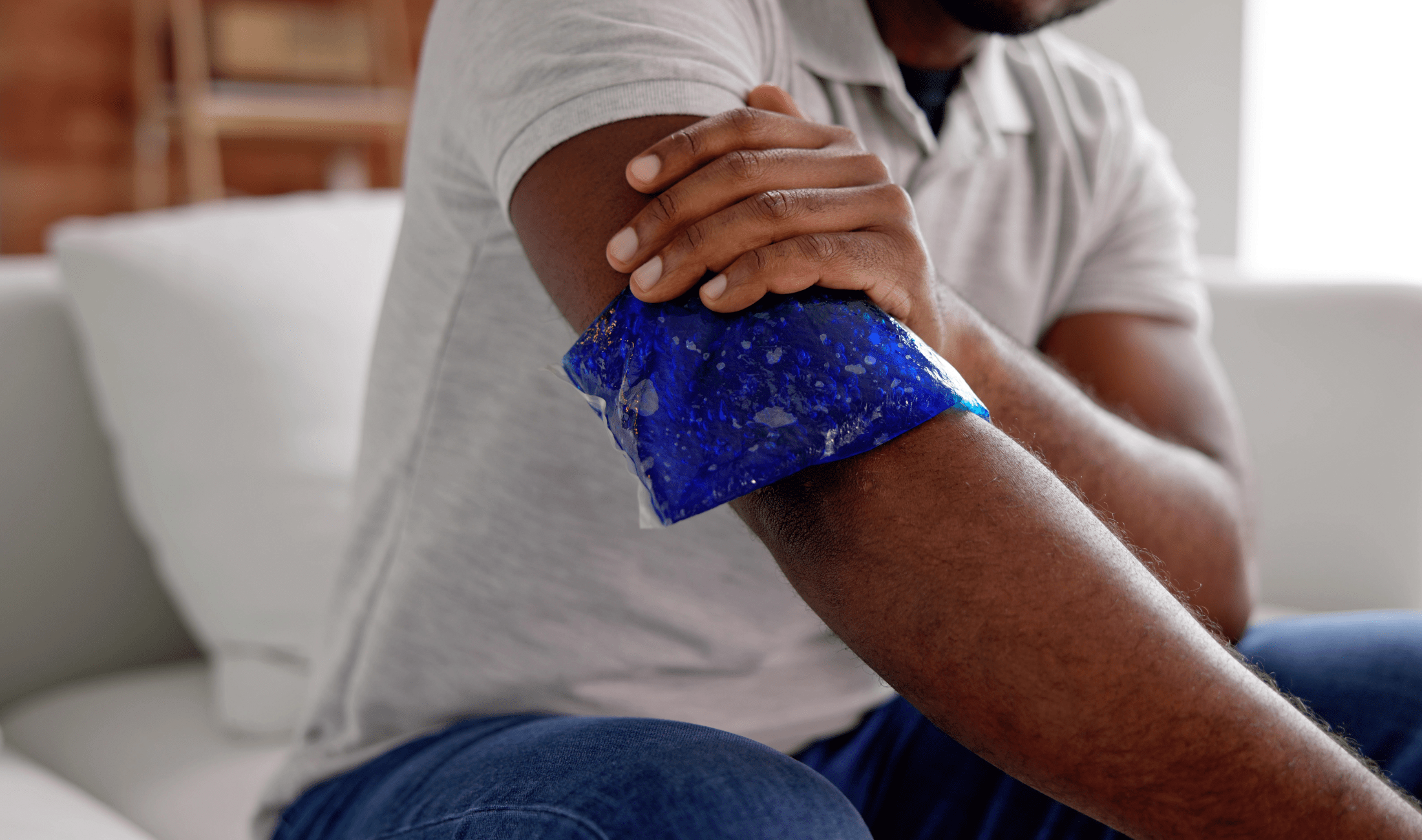 A man holding an ice pack on his arm.