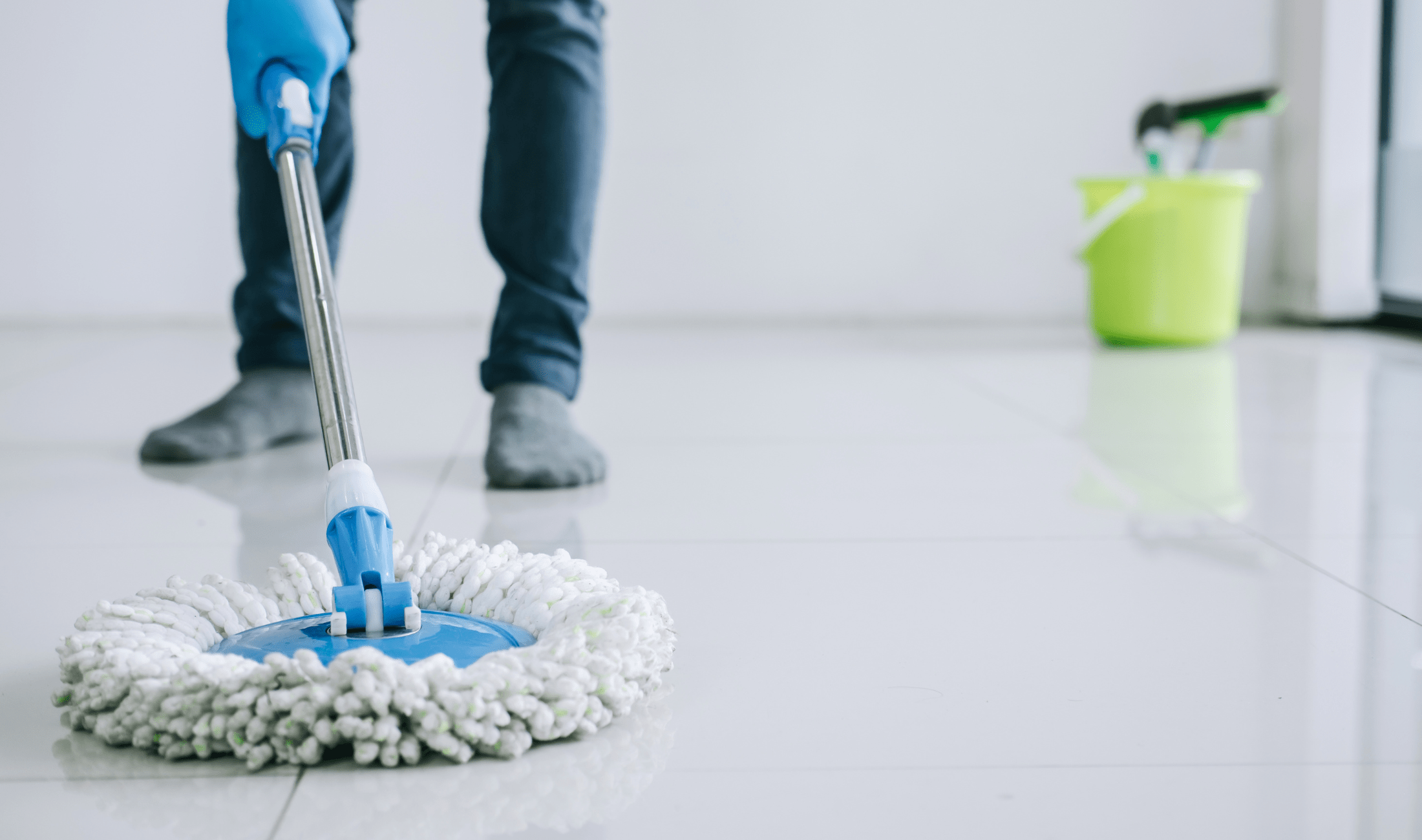 A person standin and mopping.