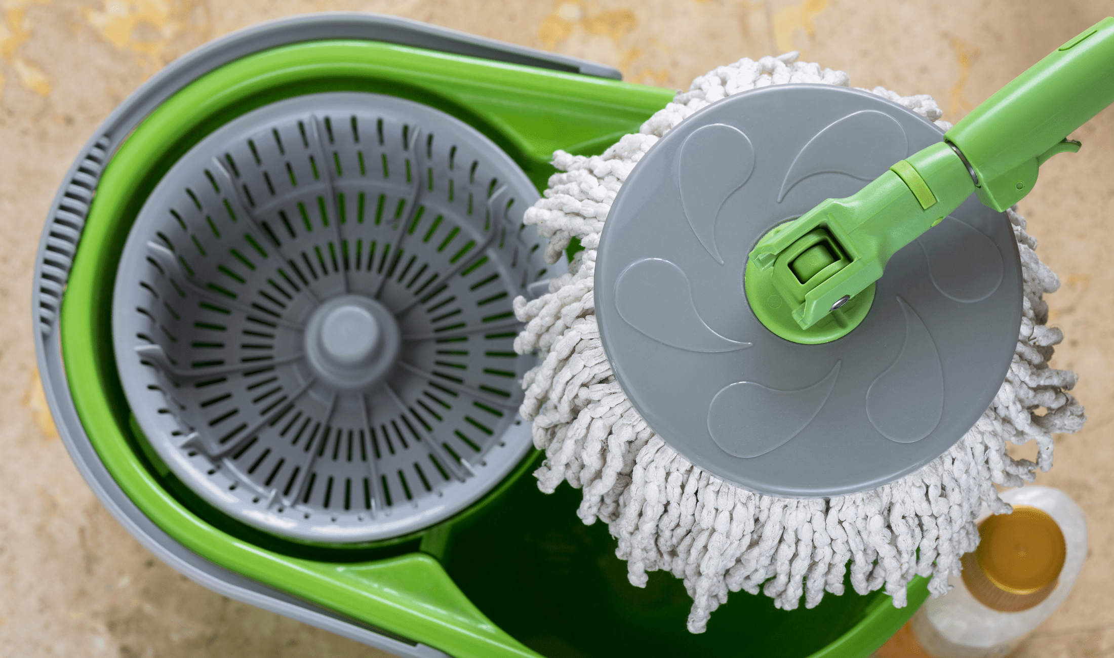 An above view of a spin mop and its bucket.