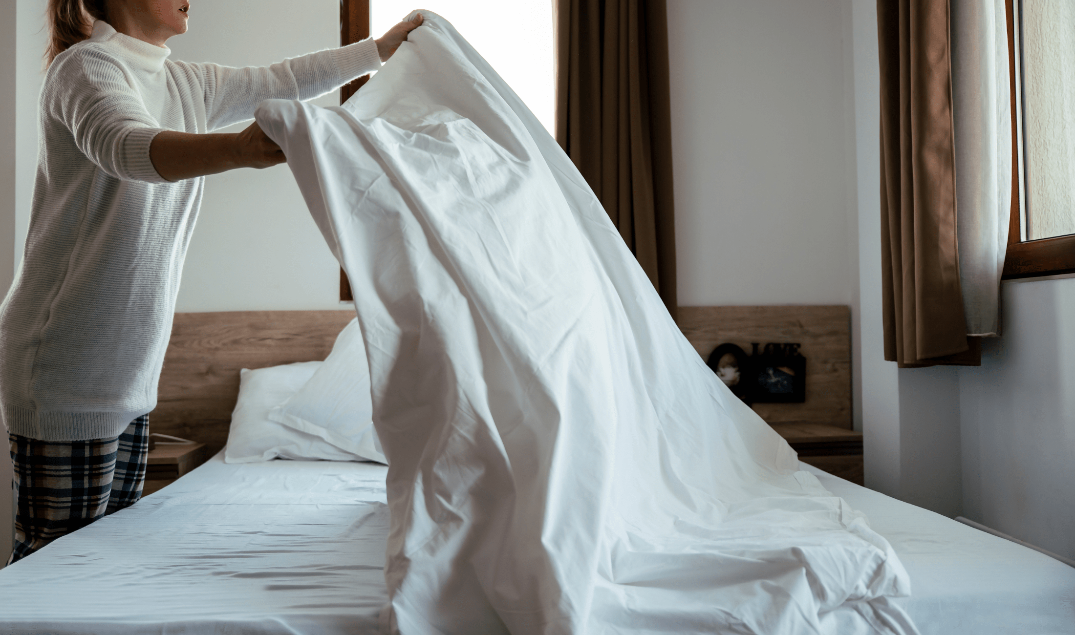 A person making their bed.