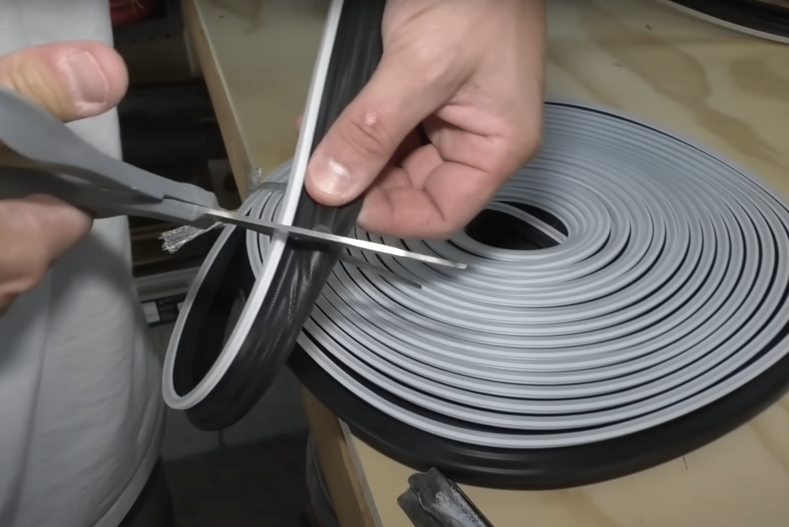 Cutting new seal with scissors.