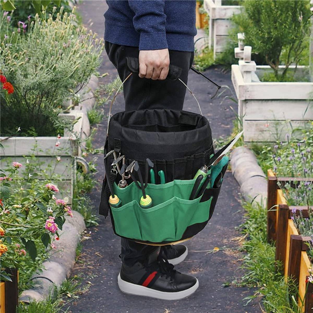 A person holding a 5gal bucket with a bucket caddy around it.