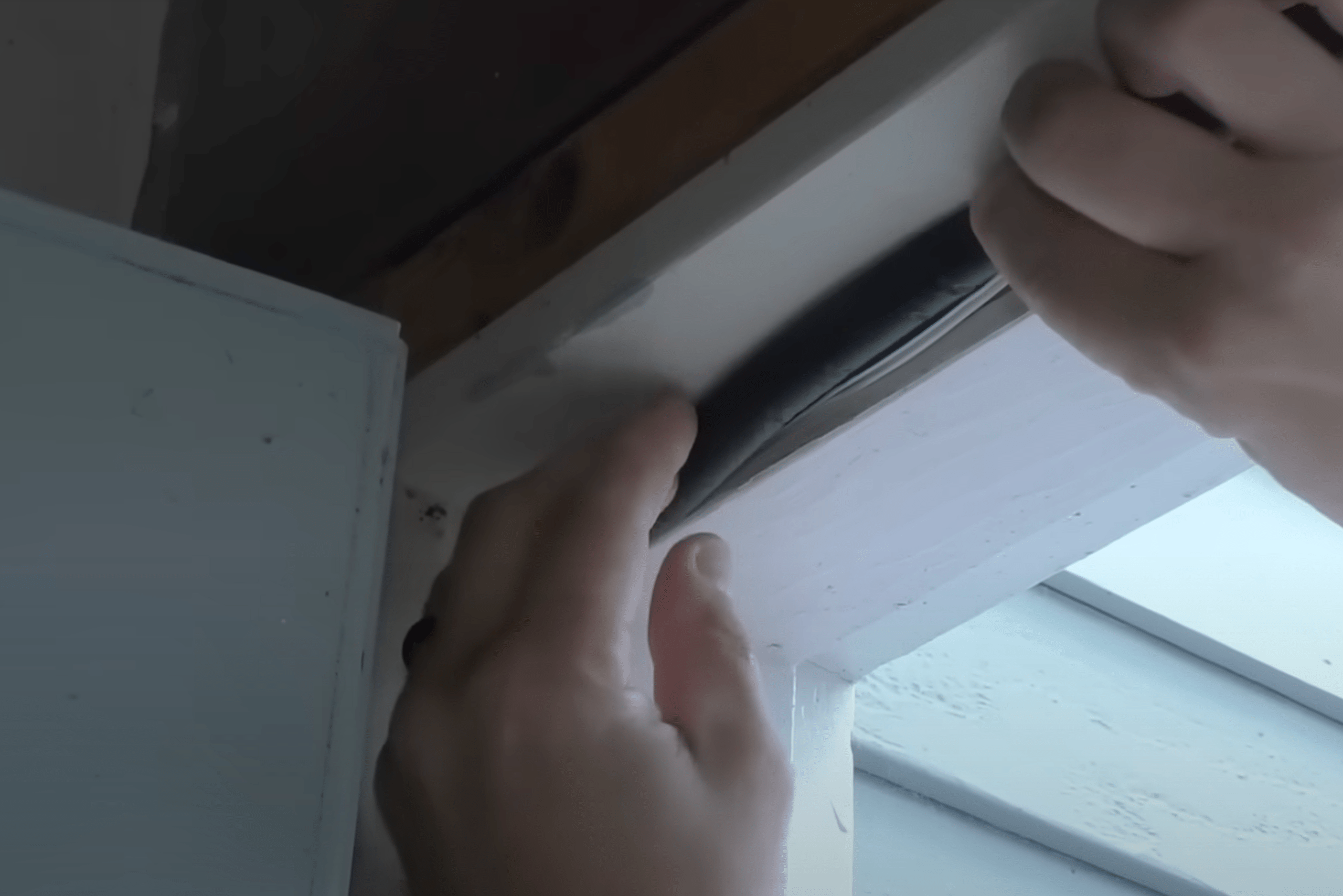 Installing new seal on door frame.