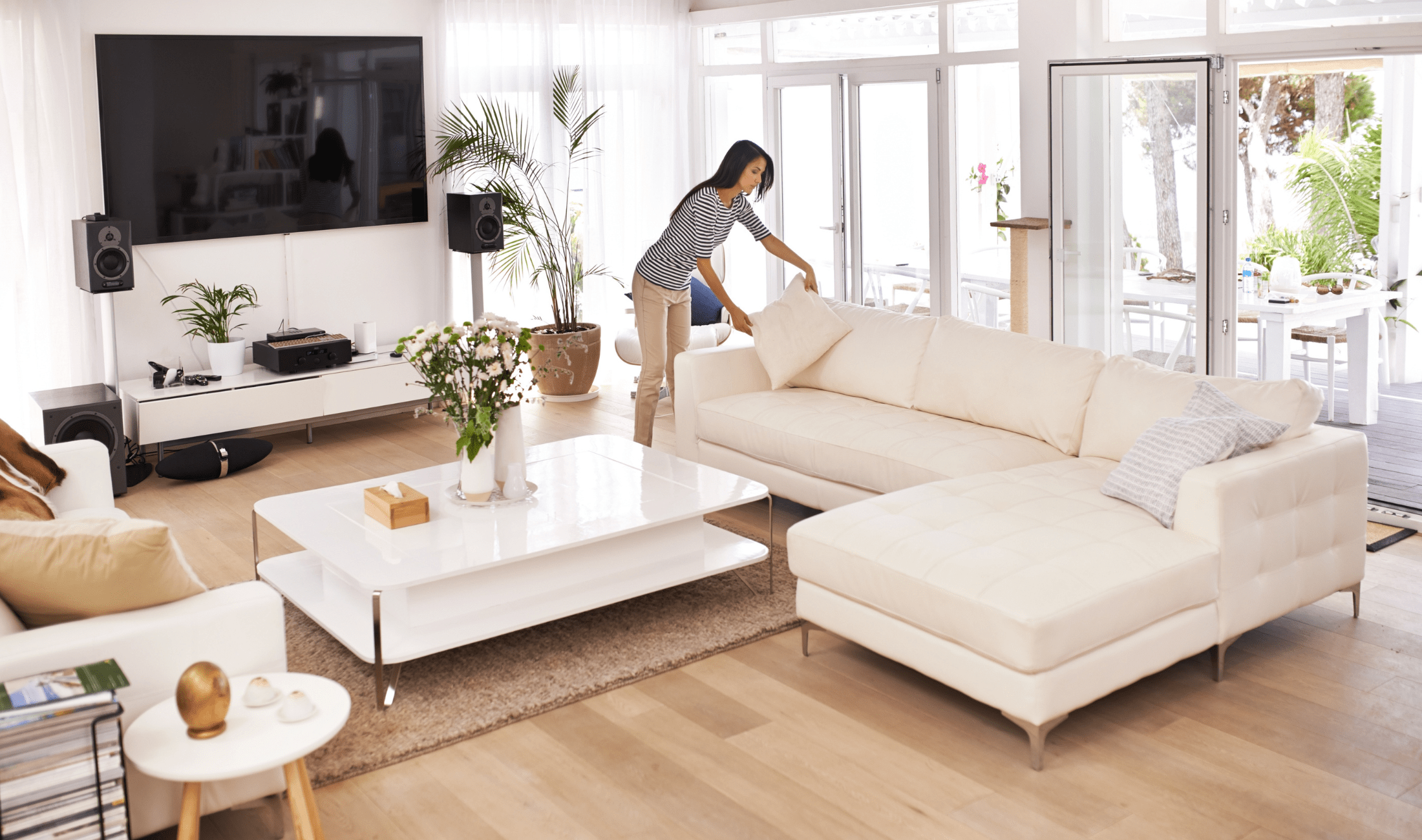 A woman tidying her living room.