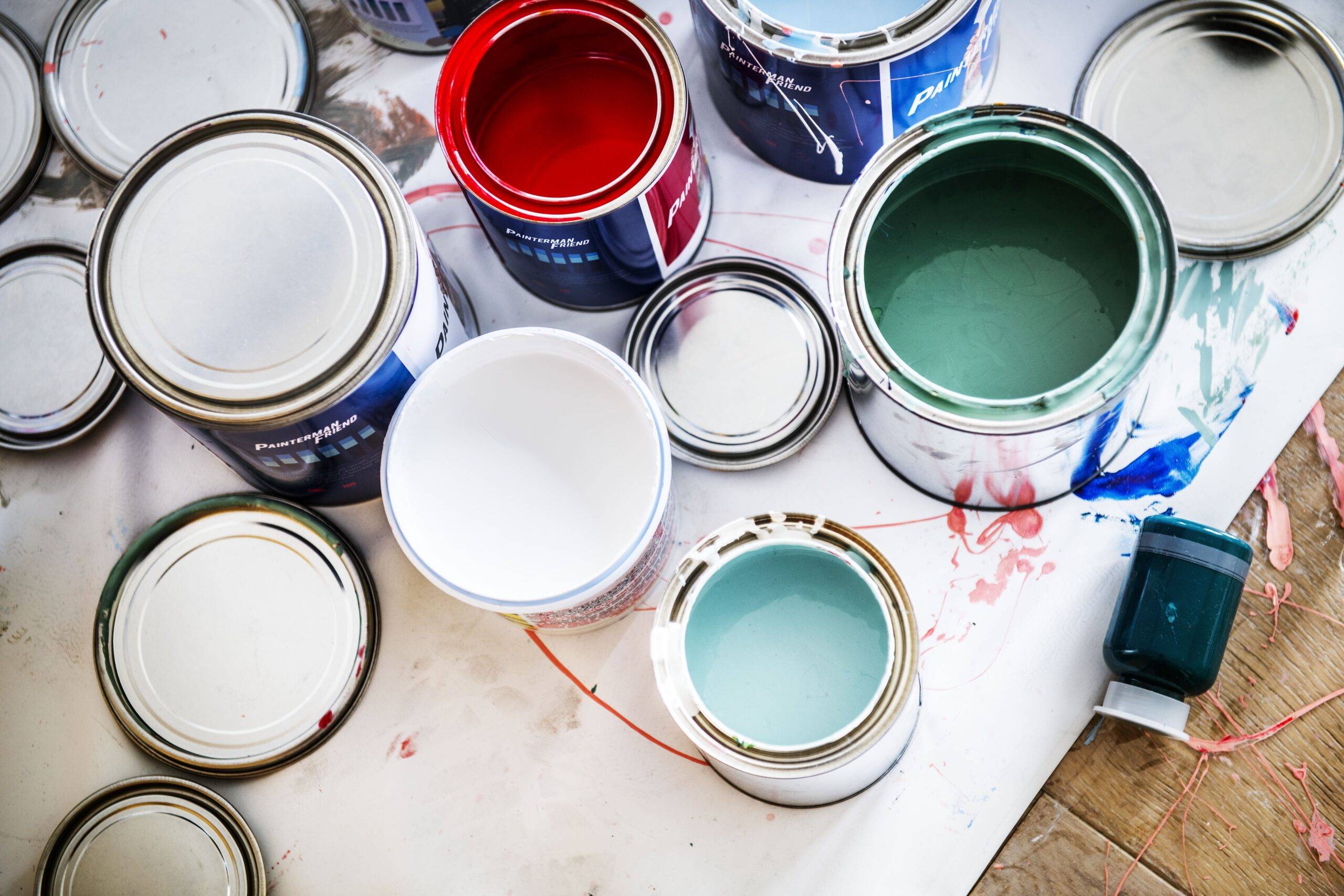 A selection of open and closed paint cans seen from above.