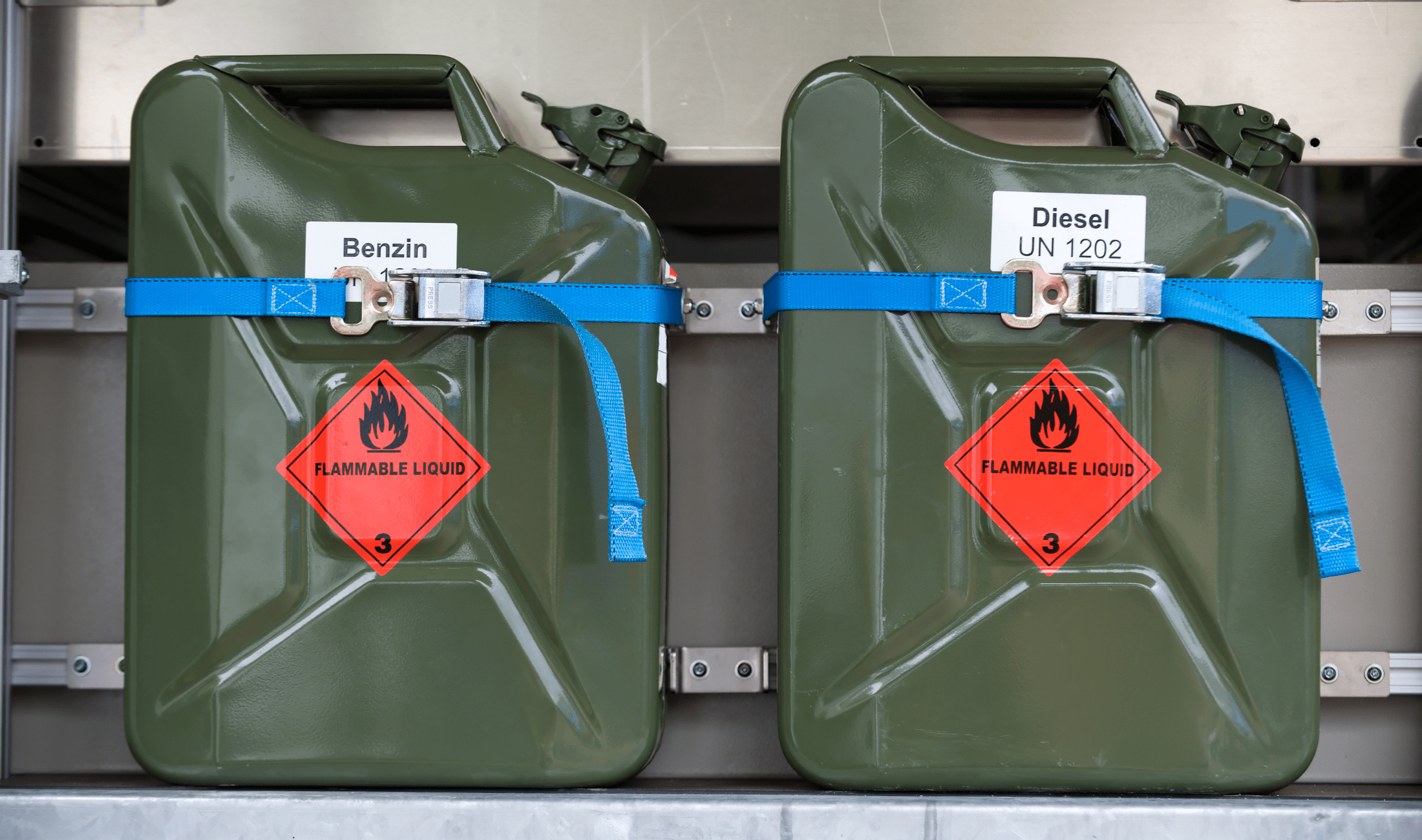 Two gas cans strapped to a platform.